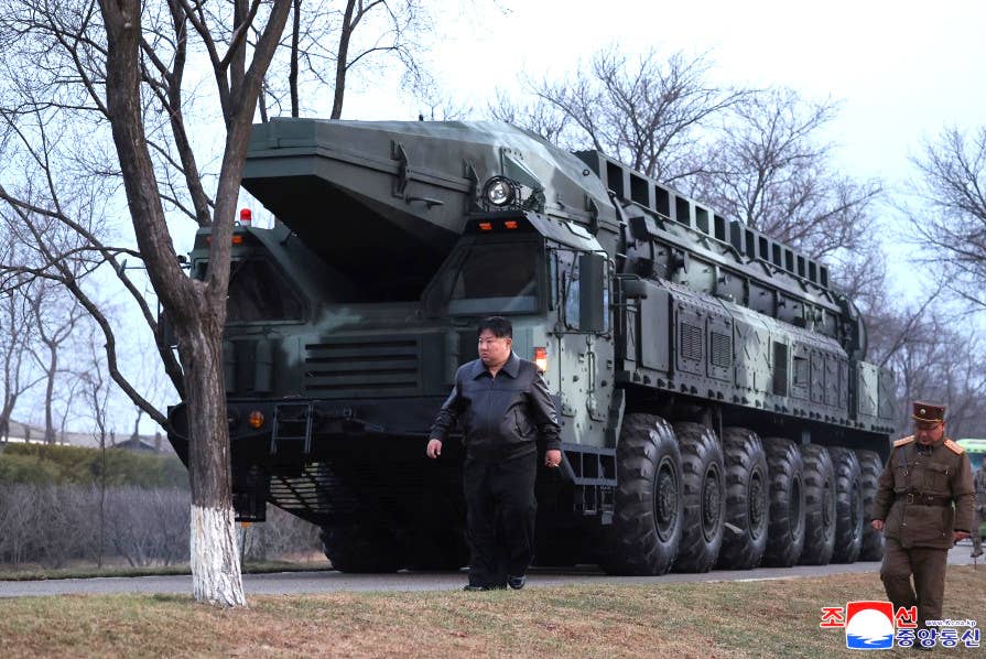 Kim Jong Un walks in front of the Hwasongpho-16B TEL ahead of the recent test launch. <em>KCNA</em>