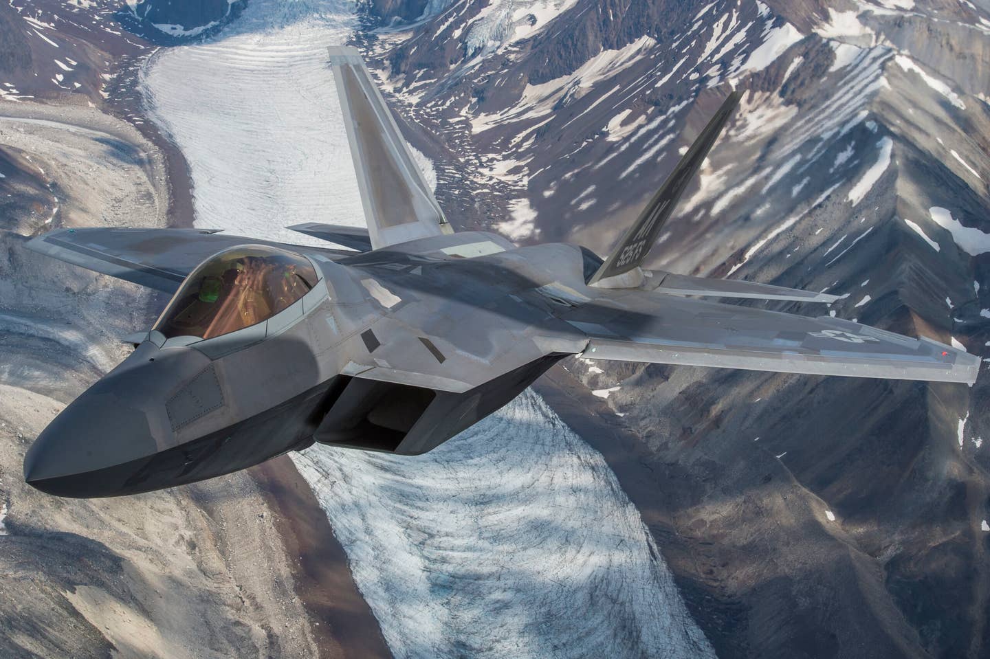 A U.S. Air Force F-22 Raptor from Joint Base Elmendorf-Richardson, flies in formation over the Joint Pacific Alaska Range Complex, July 18, 2019. The JPARC is a 67,000 plus square mile area, providing a realistic training environment commanders leverage for full spectrum engagements, ranging from individual skills to complex, large-scale joint engagements.  (U.S. Air Force photo by Staff Sgt. James Richardson)