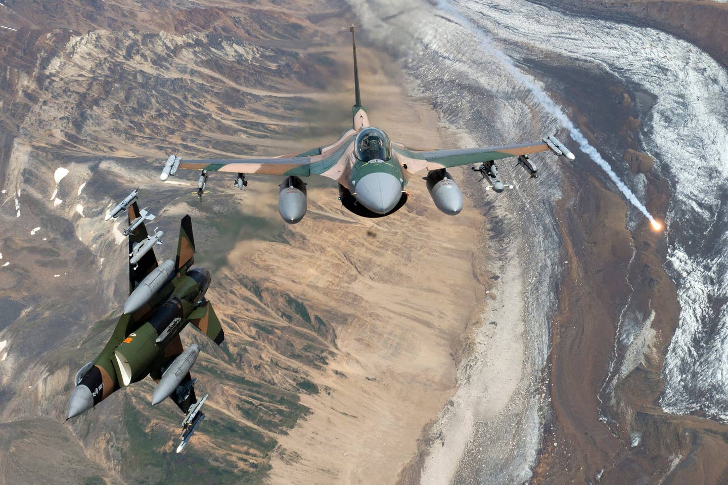 U.S. Air Force F-16 Fighting Falcons from Eielson Air Force Base, fly in formation over the Joint Pacific Alaska Range Complex on July 18, 2019. The JPARC is a 67,000 plus square mile area, providing a realistic training environment commanders leverage for full spectrum engagements, ranging from individual skills to complex, large-scale joint engagements. (U.S. Air Force photo by Staff Sgt. James Richardson)