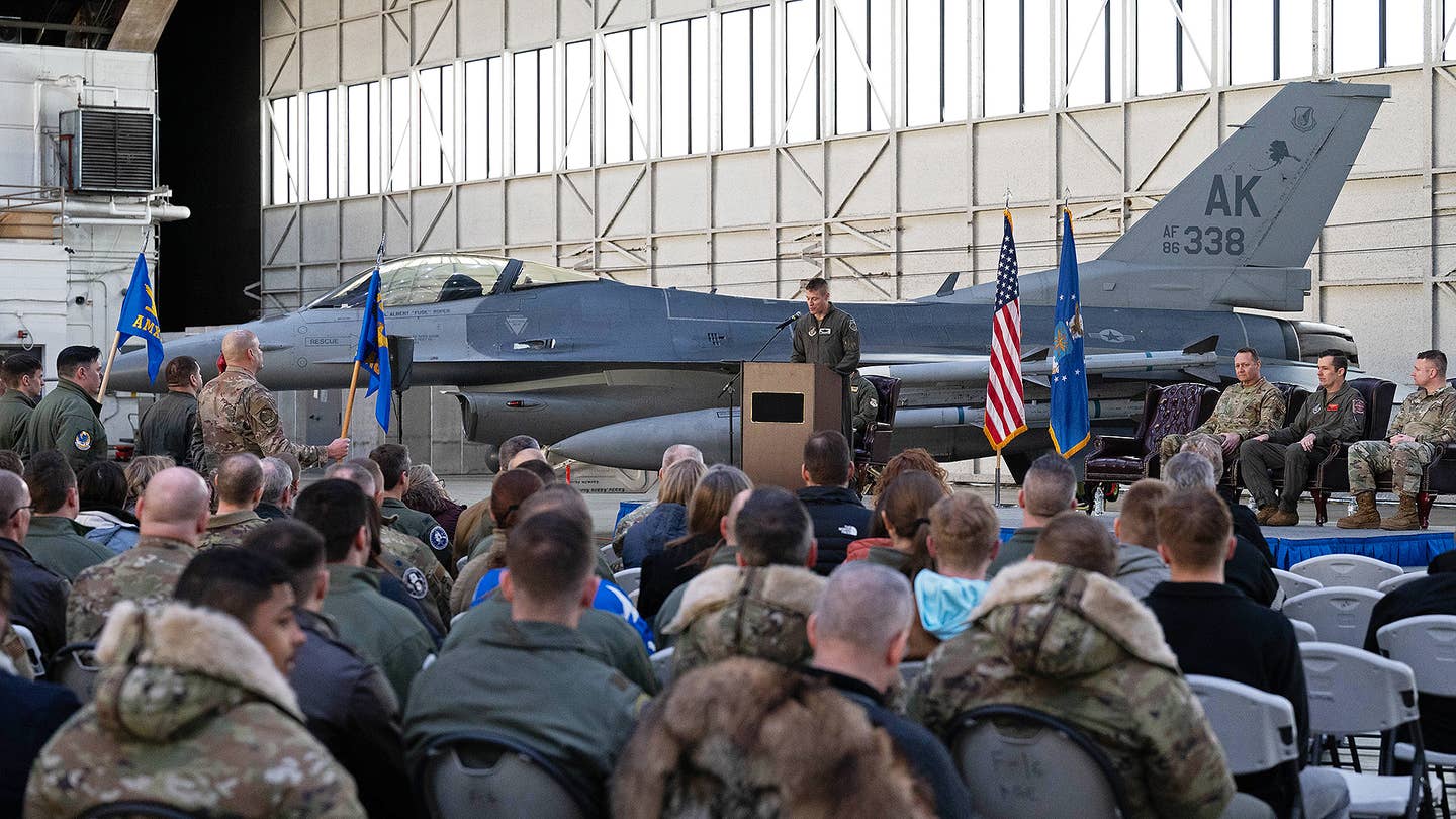 U.S. Air Force Col. Curtis Dougherty, commander, 354th Operations Group, addresses the crowd during the 18th Aggressor Squadron redesignation at Eielson Air Force Base, Alaska, Feb. 2, 2024. The 18th Fighter Interceptor Squadron has a rich history dating back to 1939. The unit has been stationed in Florida, California, and during WWII the 18th FIS participated in combat in the Northern Pacific and the defense of Alaska. (U.S. Air Force photo by Airman 1st Class Carson Jeney)
