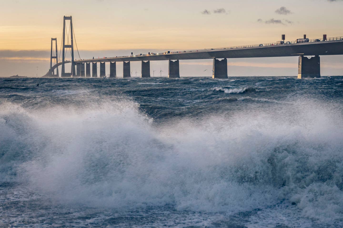 The Great Belt Bridge is seen from Zealand as waves crashes ashore, Denmark, on December 22, 2023. <em>Photo by THOMAS TRAASDAHL/Ritzau Scanpix/AFP via Getty Images</em>