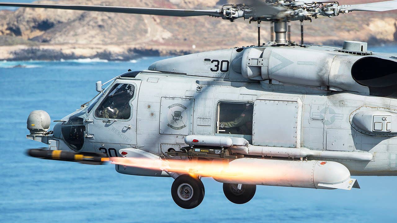 MH-60R firing a Hellfire missile. (USN)