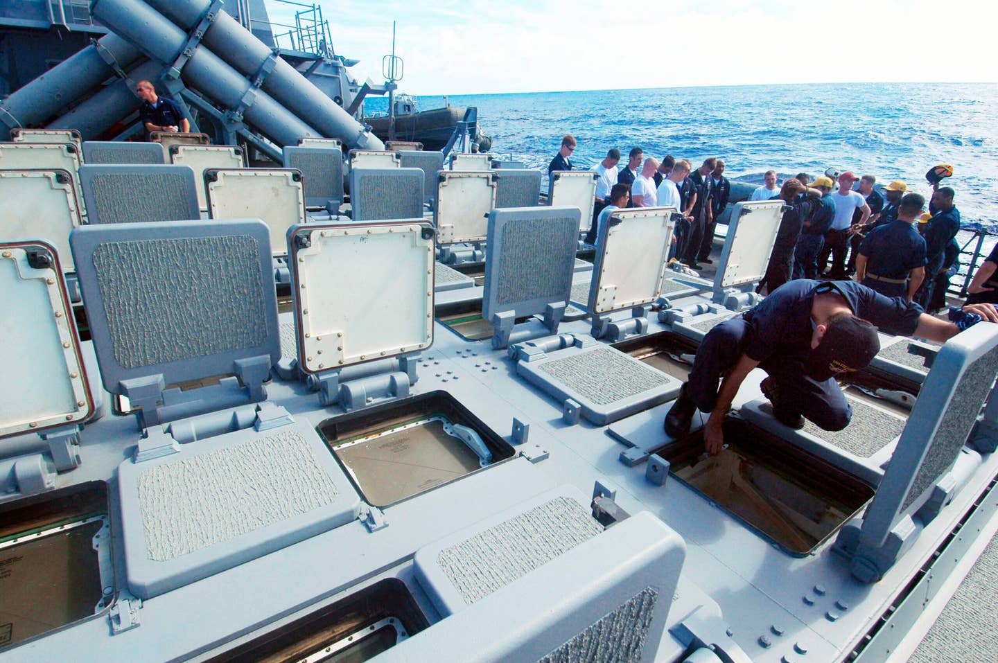 A Sailor aboard the guided-missile destroyer USS <em>Fitzgerald</em> (DDG-62) inspects the MK 41 Vertical Launching System (VLS) for water to prevent electrical failure. The MK 41 Vertical Launching System (VLS) is a canister launching system, which provides a rapid-fire launch capability against hostile threats. (U.S. Navy photo by Photographer's Mate Airman Adam York)