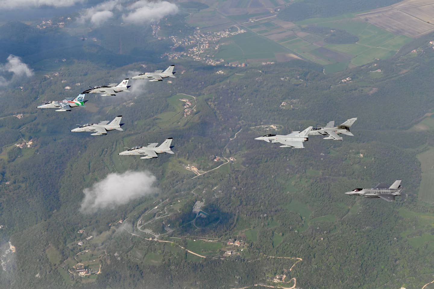 A commemorative formation put up by the last five AMX aircraft at Istrana as well as single examples of the Italian Air Force Eurofighter, Tornado, and F-35A. <em>Italian Air Force</em>