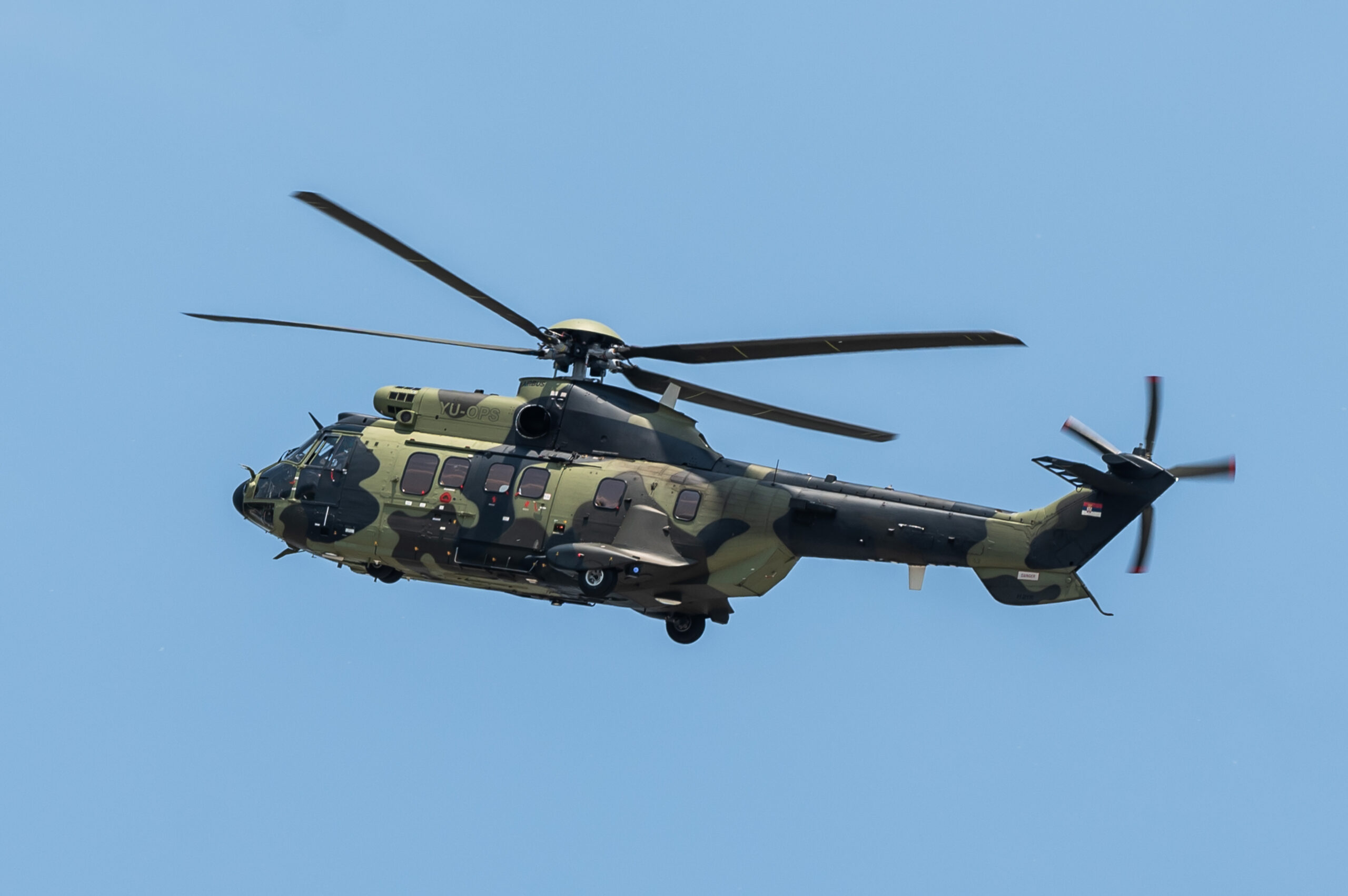 An H215 helicopter, operated by the Serbian police, flies over Nikola Tesla Airport in Belgrade, on July 10, 2023. <em>Photo by Silas Stein/picture alliance via Getty Images</em>