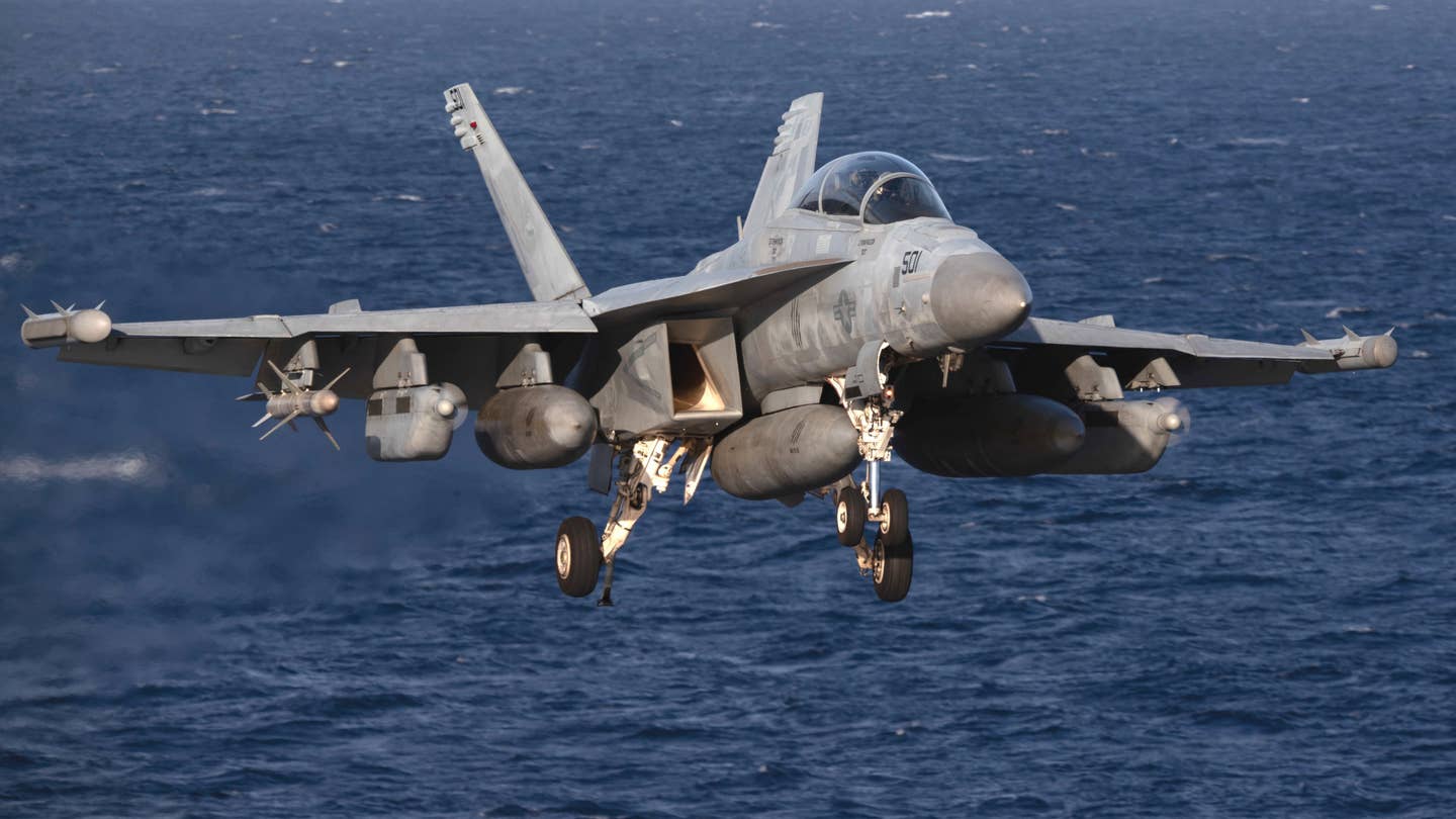 An E/A-18G Growler, attached to the "Gray Wolves" of Electronic Attack Squadron (VAQ) 142, approaches the aircraft carrier USS <em>Gerald R. Ford</em> (CVN 78), on November 28, 2023. <em>USN</em>