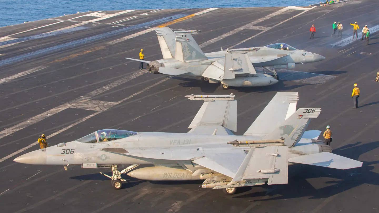 US Navy F/A-18E Super Hornets aboard the <em>Nimitz</em> class aircraft carrier USS <em>Dwight D. Eisenhower</em> (CVN 69) in the Red Sea, March 5, 2024. These aircraft have AIM-9X Sidewinders on their wingtips. USN.