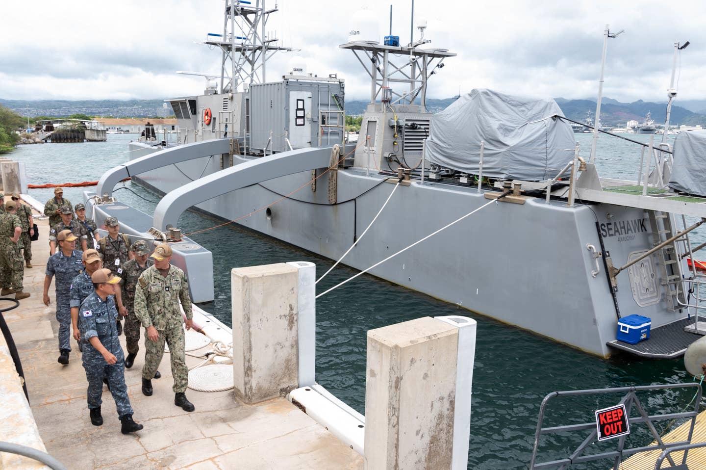U.S. Navy Cmdr. Jeremiah Daley (right) speaks to Republic of Korea Navy Sailors aboard the medium unmanned surface vessel <em>Sea Hawk</em> during Rim of the Pacific (RIMPAC) 2022, July, 7, 2022. <em>U.S. Navy photo by Mass Communication Specialist 2nd Class Maria G. Llanos</em>