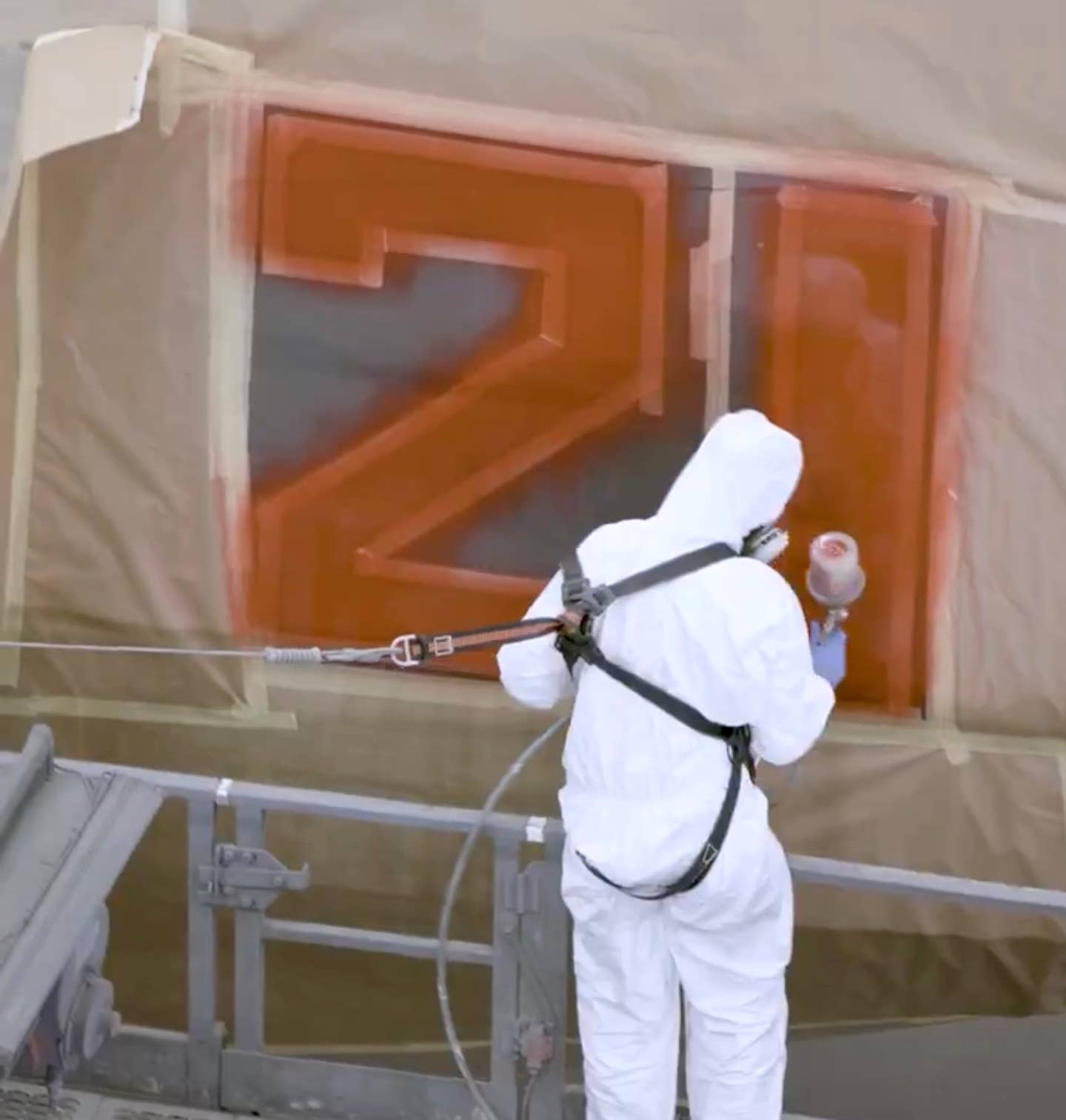 "Bort" markings being applied via spray paint gun. <em>Airbus Defense via X</em>