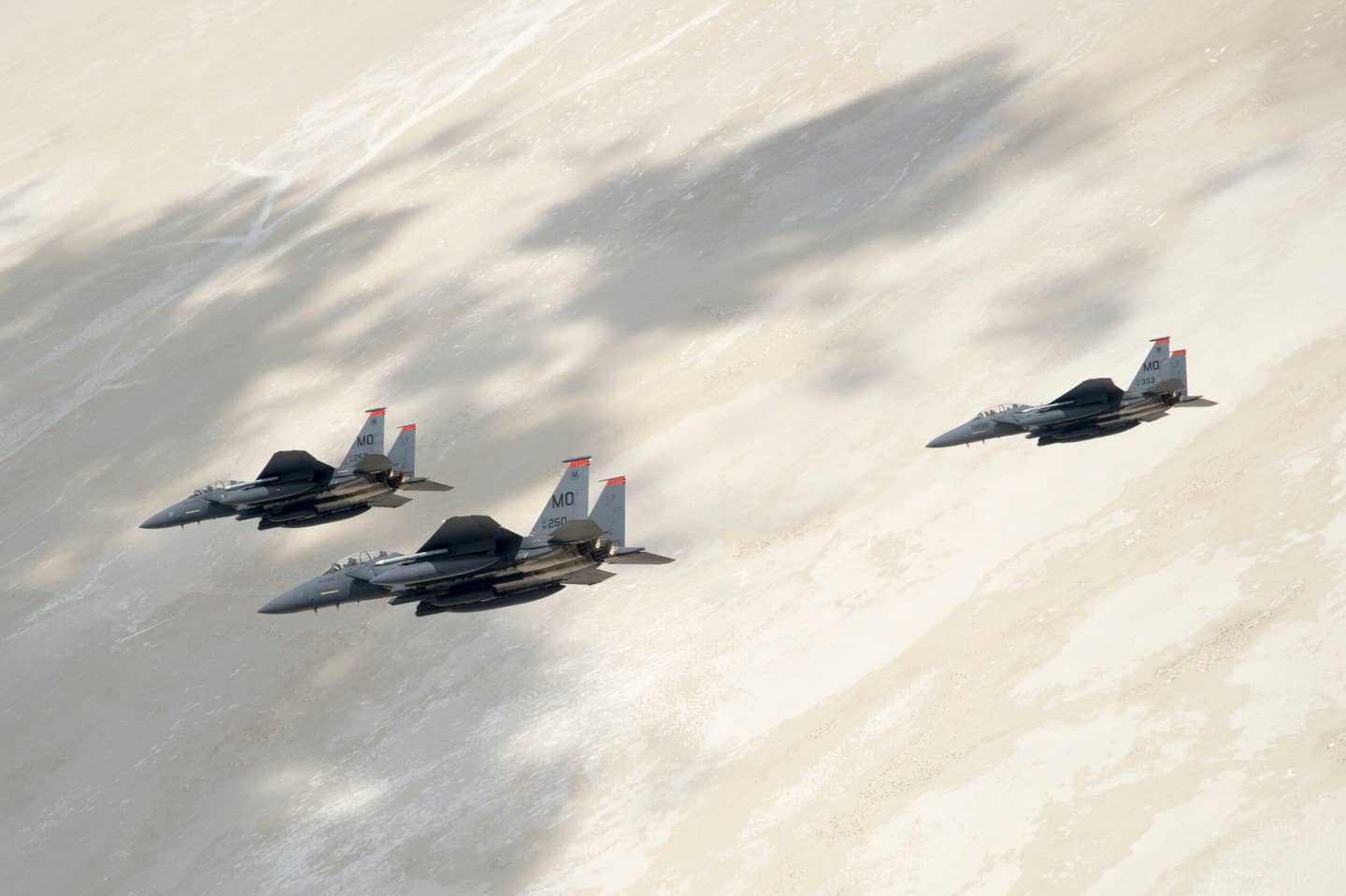 Three U.S. Air Force F-15E Strike Eagles, assigned to the 391st Fighter Squadron from Mountain Home Air Force Base, Idaho, fly over the Utah Test and Training Range, July 3, 2018. The F-15E Strike Eagle is a dual-role fighter designed to perform air-to-air and air-to-ground missions. (U.S. Air Force photo by Airman 1st Class Codie Trimble)