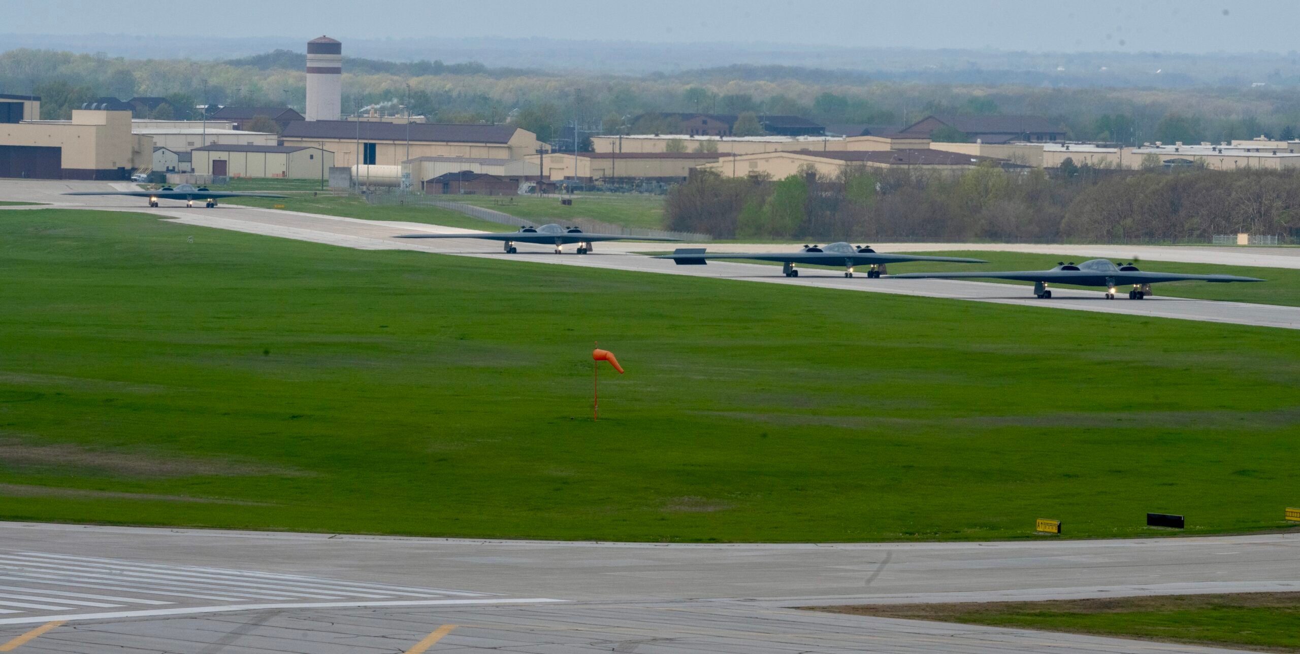B-2 Spirit stealth bombers assigned to the 509th Bomb Wing taxi on the runway at Whiteman Air Force Base, Mo., April 15, 2024. Team Whiteman executed a mass fly-off of 12 B-2s to cap off the annual Spirit Vigilance exercise. Routine training ensures that Airmen are always ready to execute global strike operations… anytime, anywhere. (U.S. Air Force photo by Airman 1st Class Hailey Farrell)