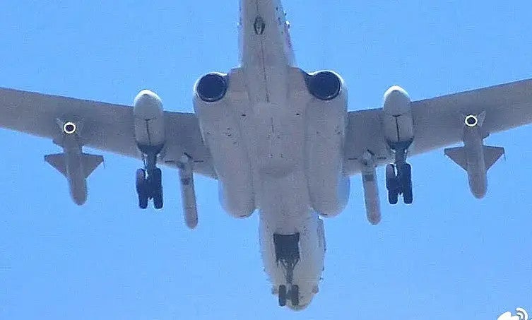 A view of the underside of an H-6N, showing the semi-recessed area on the centerline a hardpoint for a very large missile, as well as conventional anti-ship missiles below the wings. Chinese Internet 