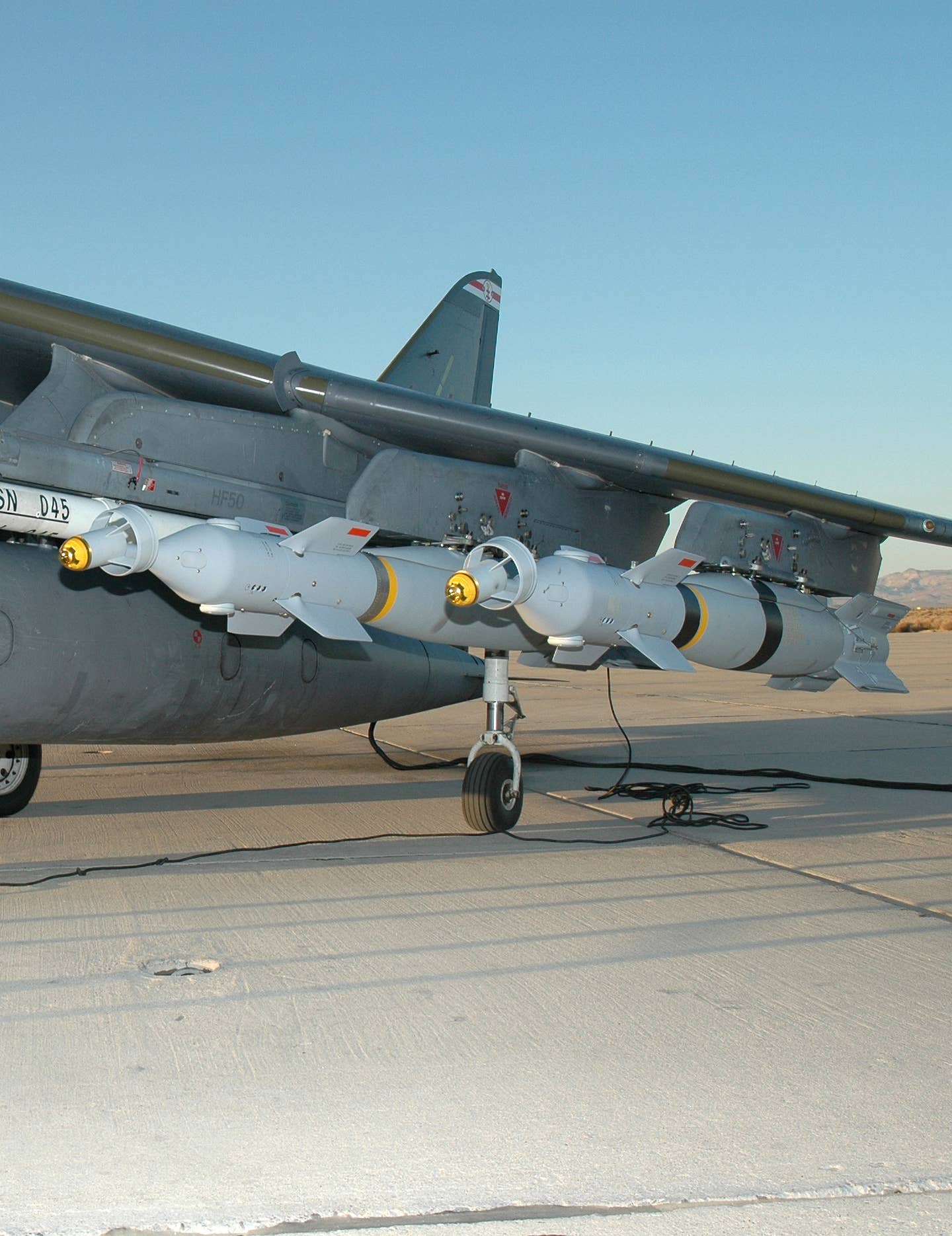 Paveway IV bombs can be seen underneath the wings of a Harrier GR9 prior to a sortie over Afghanistan. <em>Crown Copyright</em>