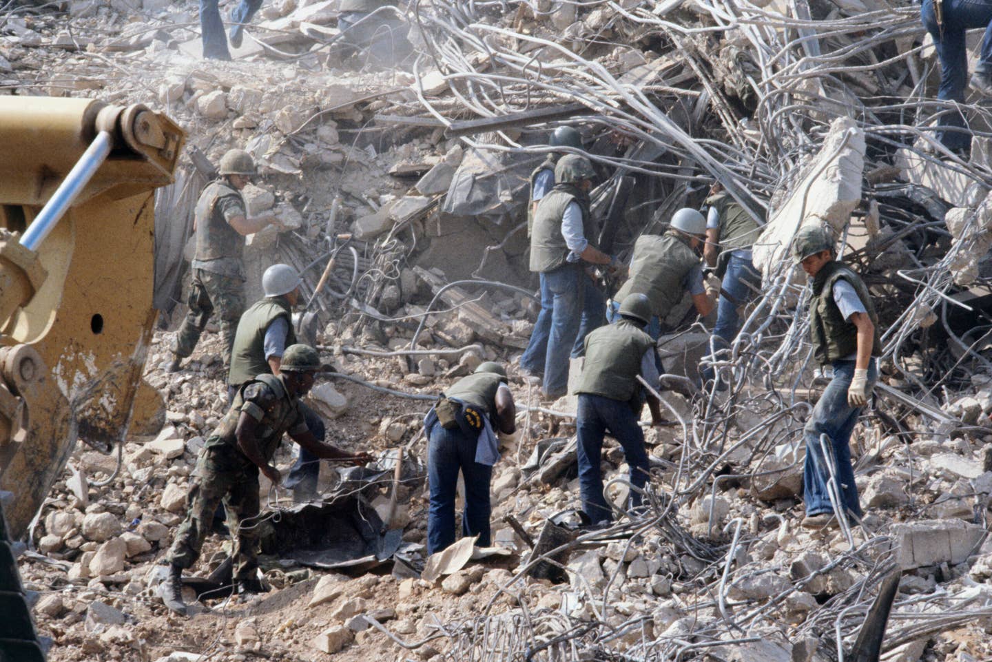 American Marines search for survivors and bodies in the rubble, all that was left of their barracks headquarters in Beirut, after a terrorist suicide car bomb was driven into the building and detonated, killing 241 US servicemen and wounding over 60. (Photo by Peter Charlesworth/LightRocket via Getty Images)
