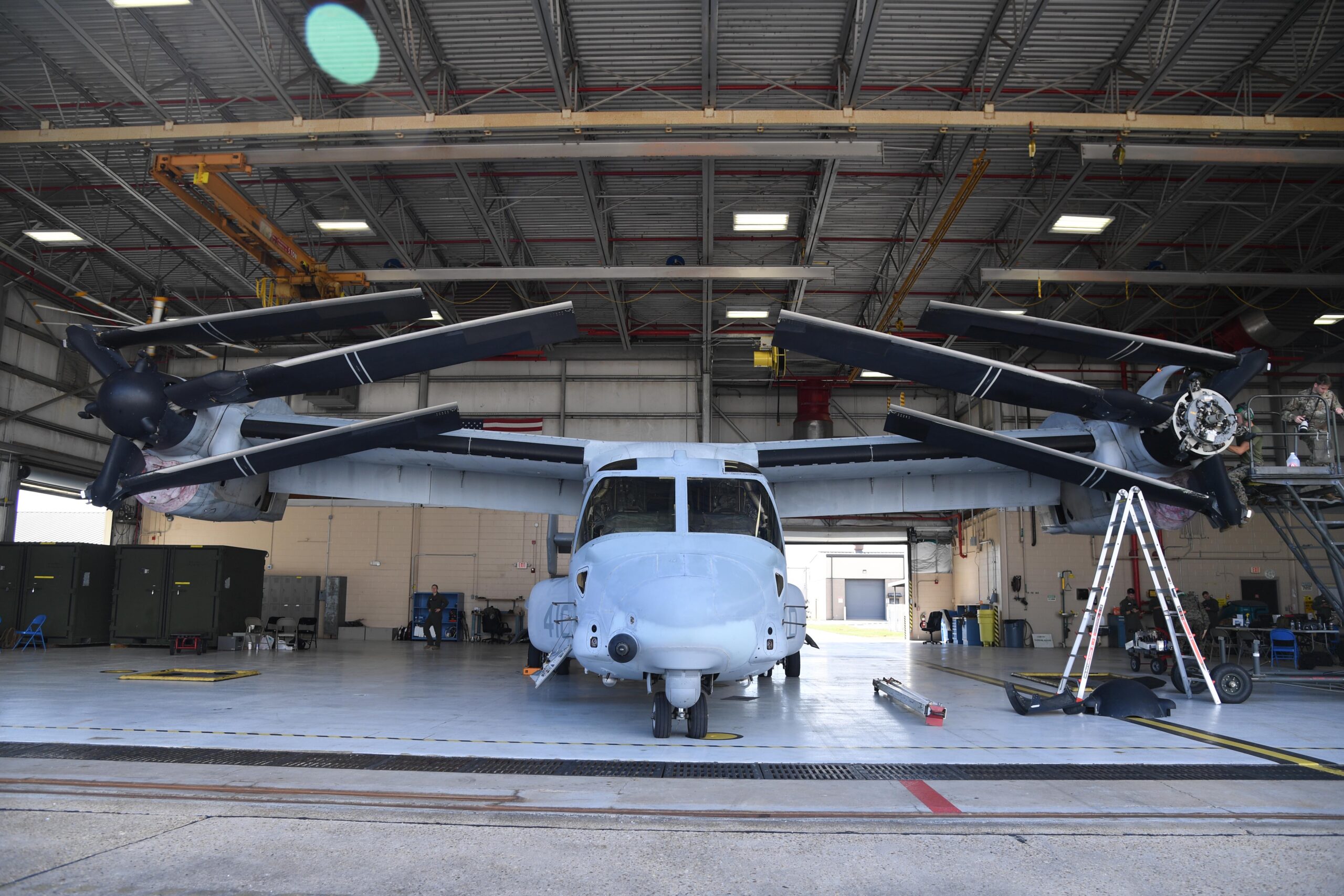 A MV-22B Osprey from Marine Medium Tiltrotor Squadron 774, Naval Air Station Norfolk, Virginia, receives routine maintenance inside a hangar at Keesler Air Force Base, Mississippi, October 2020. <em>U.S. Air Force photo by Kemberly Groue</em>