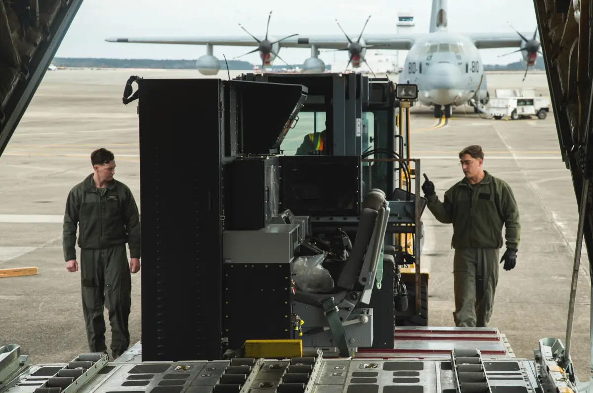 Marines load Harvest Hawk's roll-on/roll-off operator station onto a KC-130J. <em>USMC</em>