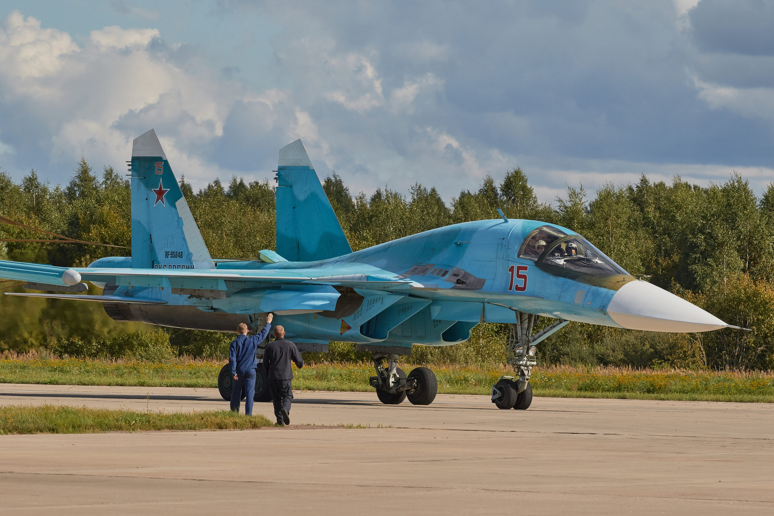 Ground crew greet a nuclear-capable Russian Aerospace Forces Su-34 Fullback strike aircraft on the runway. <em>Photo by Mihail Tokmakov/SOPA Images/LightRocket via Getty Images</em>