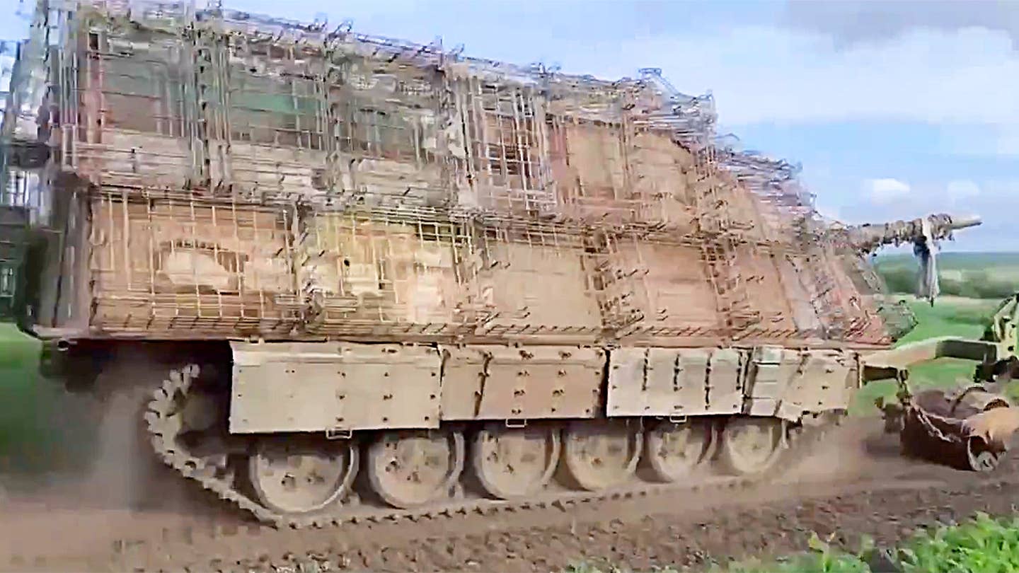 Russian 'turtle tank' seen operating with additional cage armor and an attached mine roller
