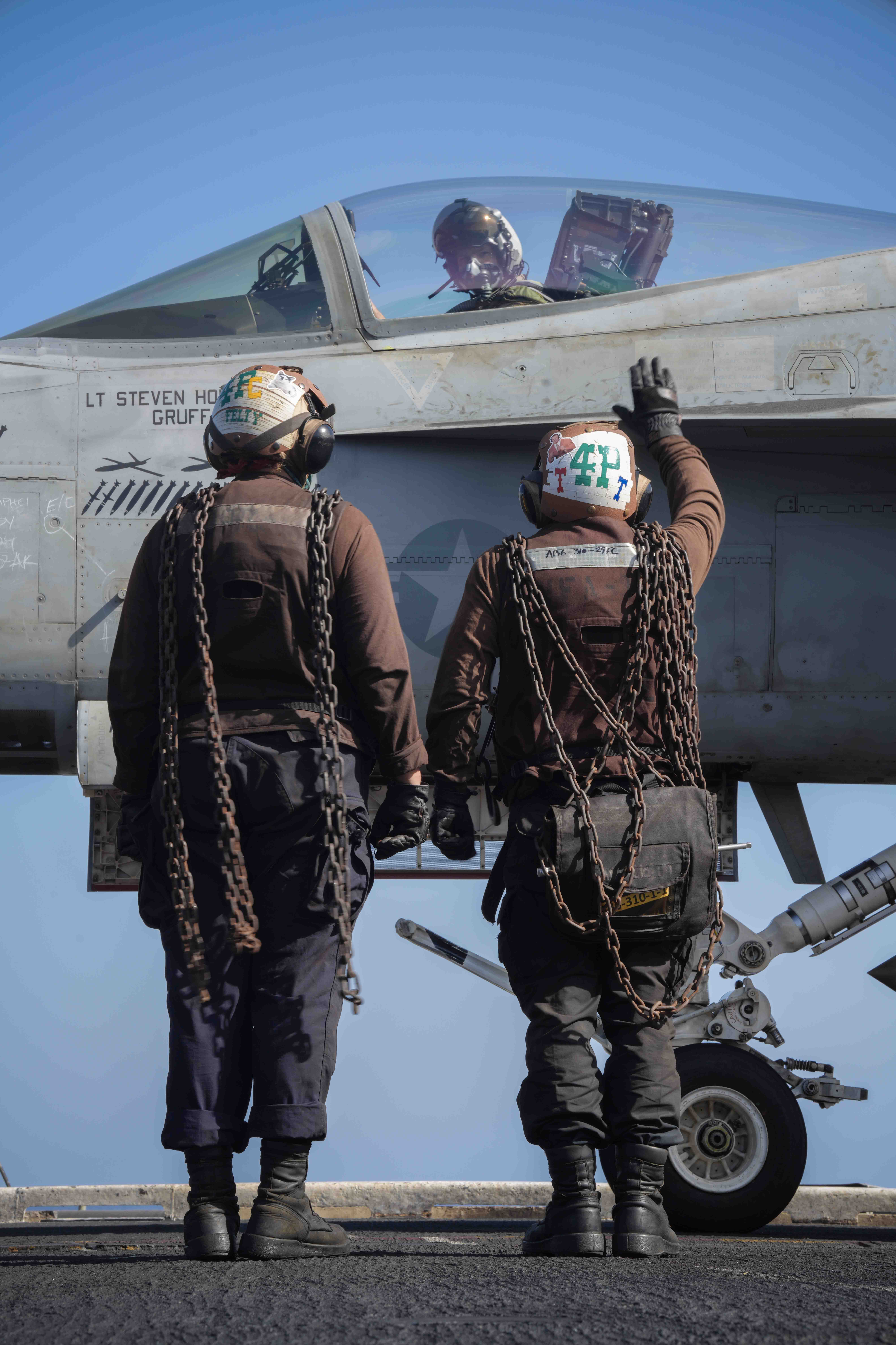 Sailors prepare to launch an F/A-18E of VFA-105, aboard USS <em>Dwight D. Eisenhower</em> in the Red Sea, on April 20. The jet wears drone kill markings as well as bomb and AGM-88 HARM symbols denoting successful air-to-ground strike missions. <em>Official U.S. Navy photo</em>