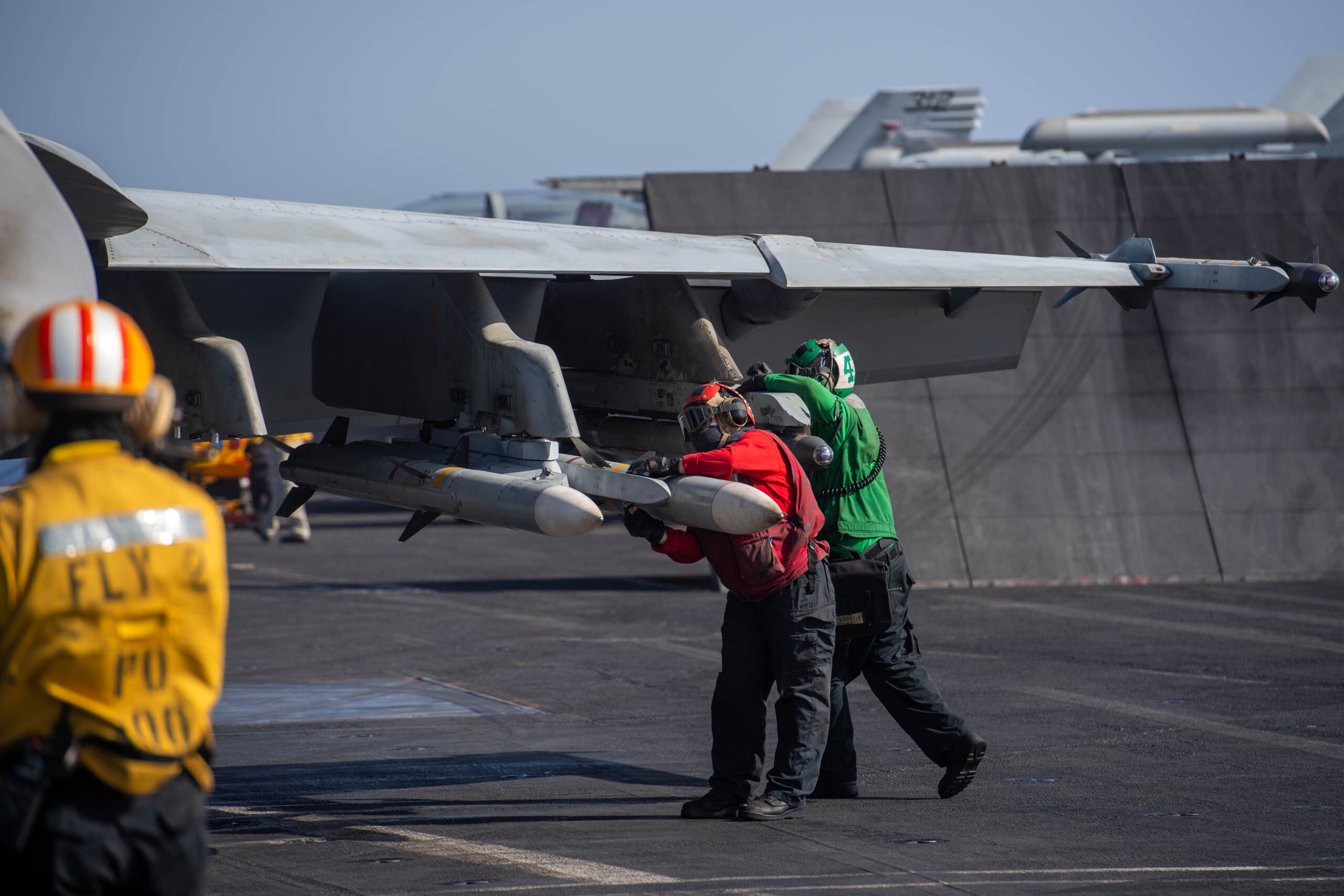 An Aviation Ordnanceman and an Aviation Electronics Mate prepare an F/A-18E of VFA-105 aboard the IKE in the Red Sea, on April 20. Each wing of the Super Hornet carries four AMRAAMs and two AIM-9X Sidewinders. <em>Official U.S. Navy photo</em>