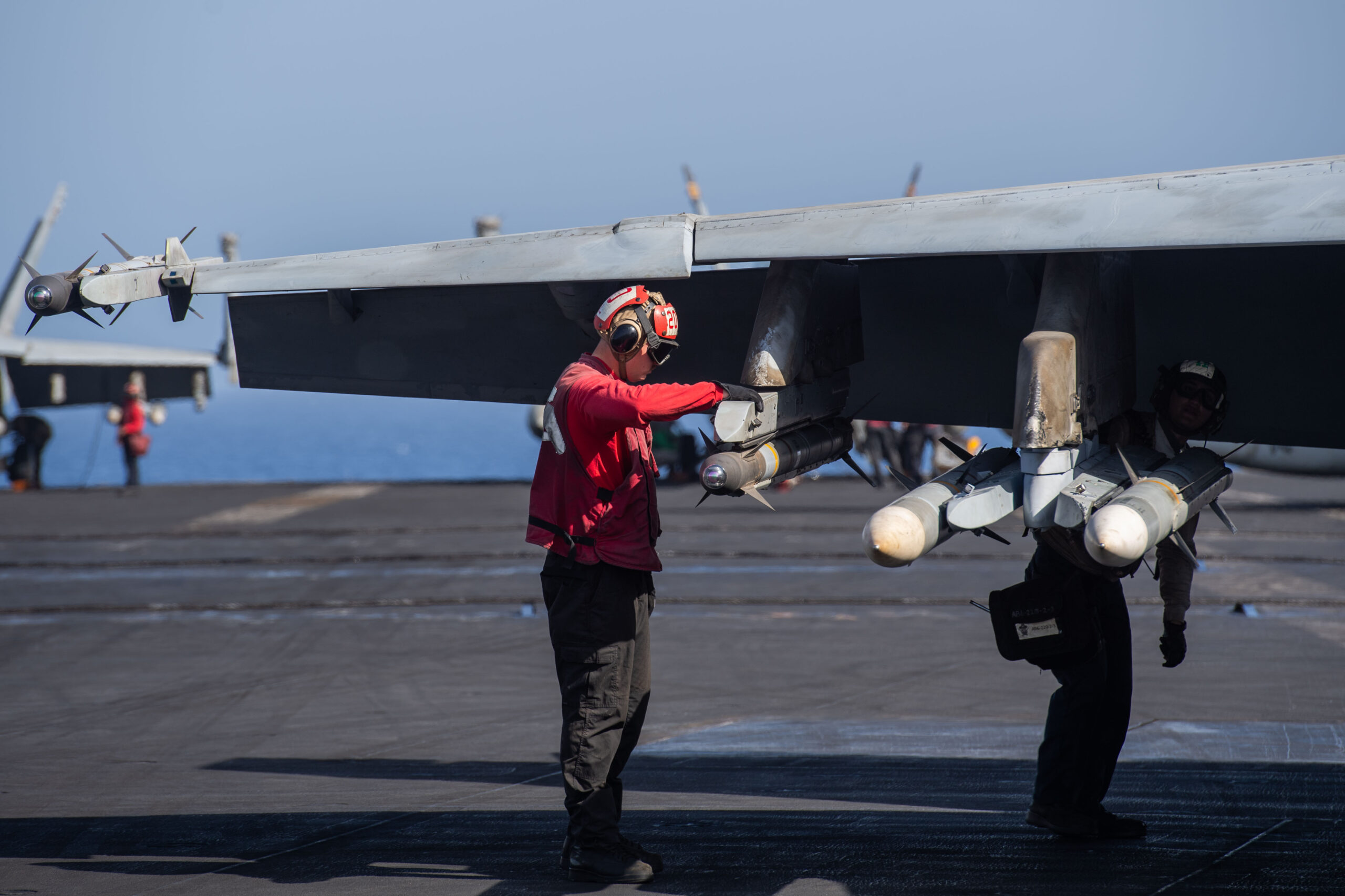 An Aviation Ordnanceman preps an AIM-9X in its new position on the outboard underwing pylon of an F/A-18E attached to VFA-105, aboard the USS <em>Dwight D. Eisenhower</em> in the Red Sea, on April 20. <em>Official U.S. Navy photo</em>