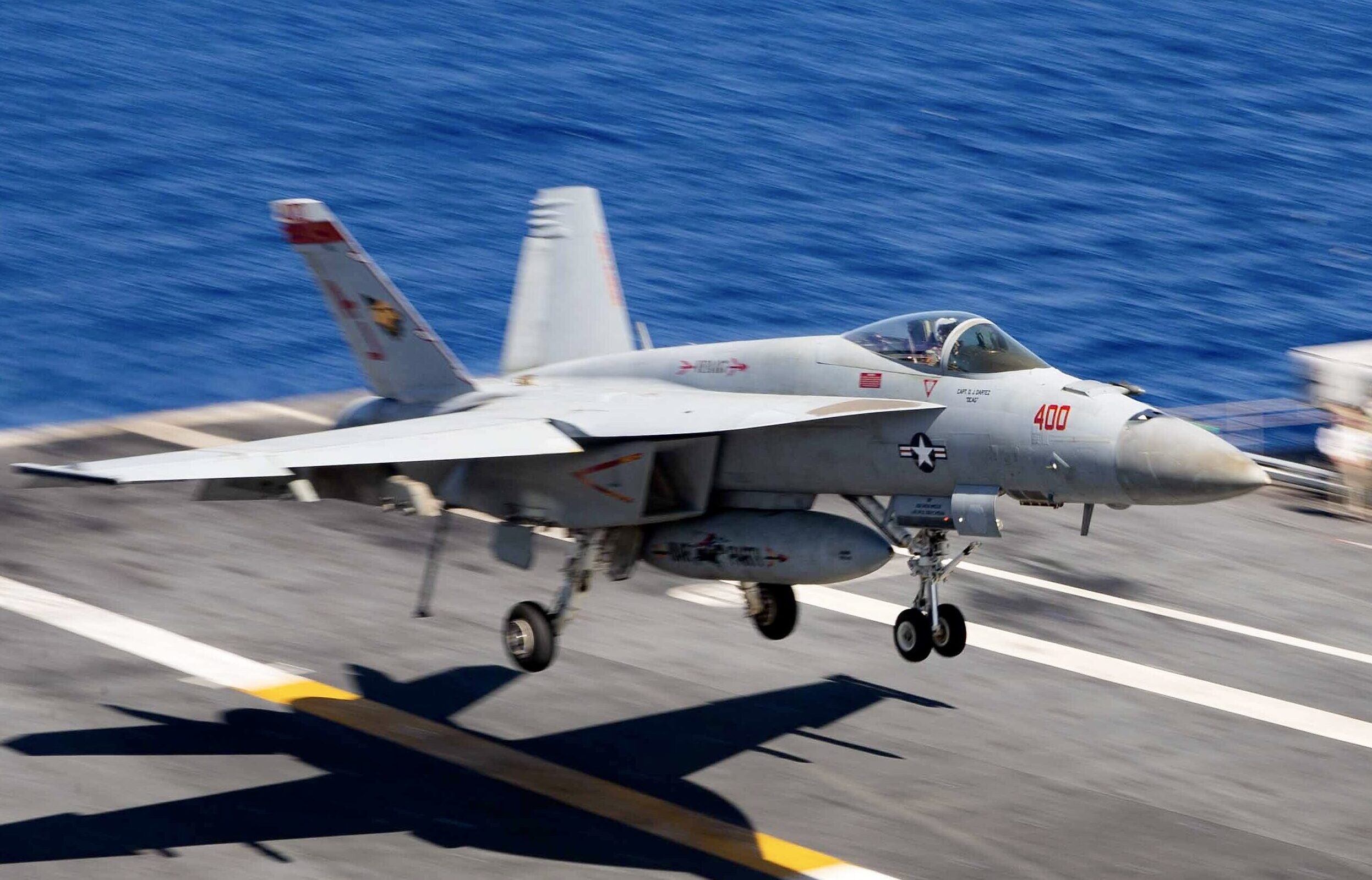 An F/A-18E Super Hornet, attached to the “Golden Warriors” of Strike Fighter Squadron (VFA) 87, approaches the flight deck of USS <em>Gerald R. Ford</em>, August 6, 2023. <em>U.S. Navy photo by Mass Communication Specialist Seaman Tajh Payne</em>