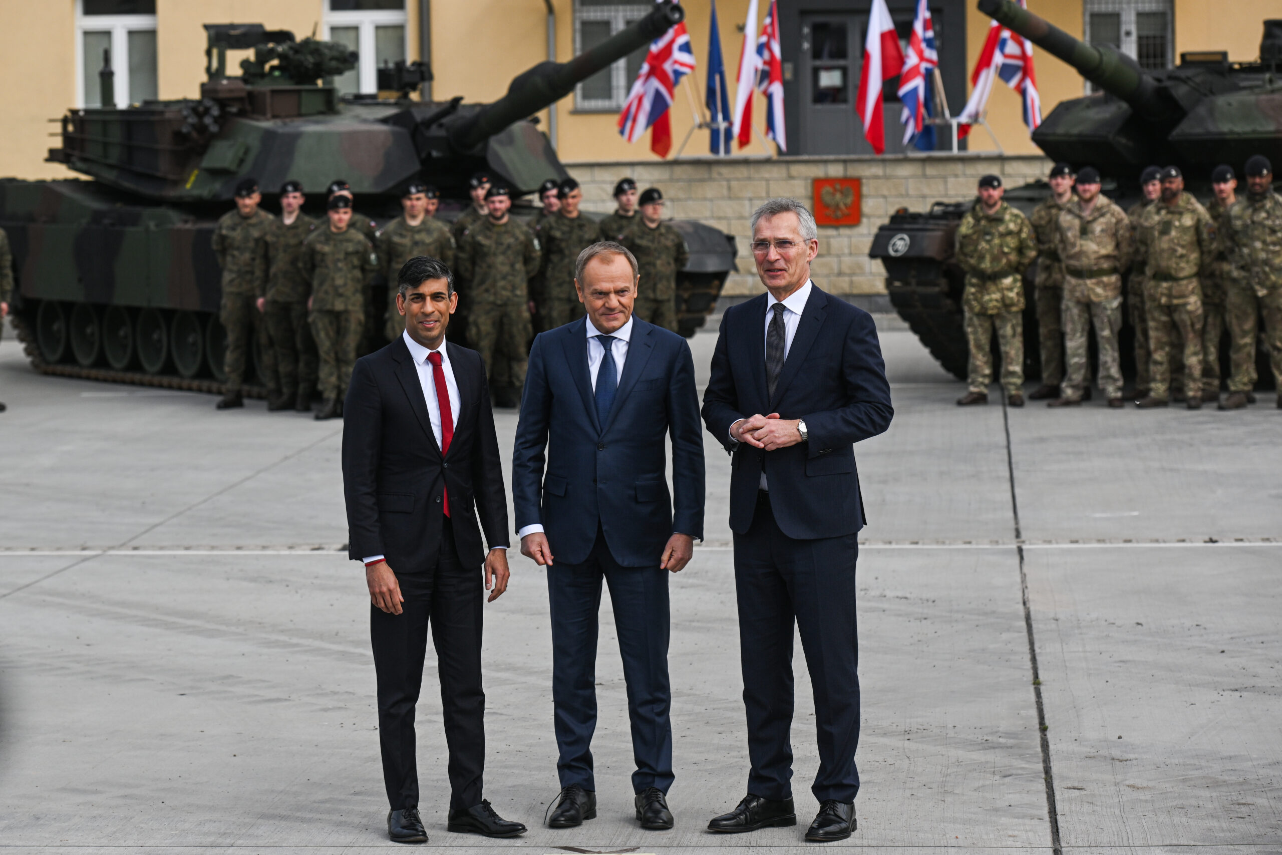 Polish Prime Minister Donald Tusk (center), NATO Secretary General Jens Stoltenberg (right), and British Prime Minister Rishi Sunak (left) ahead of a meeting with troops at the 1st Warsaw Armoured Brigade in Warsaw, Poland, on April 23, 2024. <em>Photo by Omar Marques/Getty Images</em>