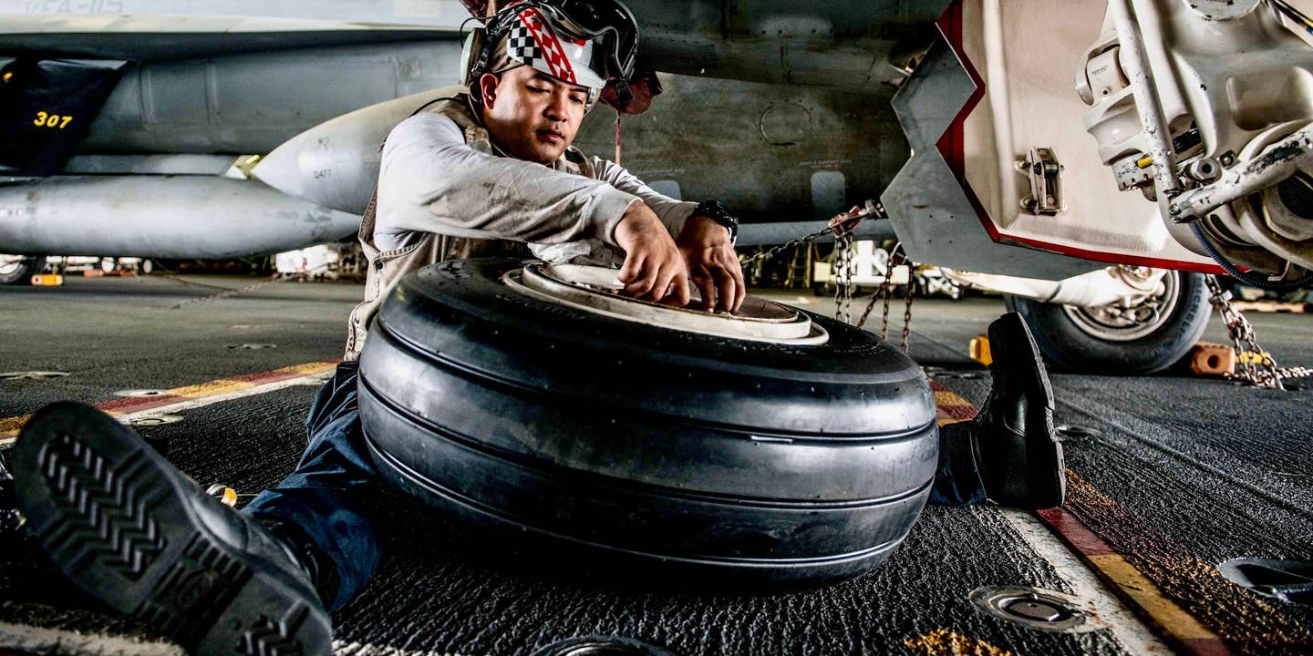 161013-N-OI810-093 WATERS SURROUNDING THE KOREAN PENINSULA (Oct. 13, 2016) Petty Officer 1st Class (AW/SW) John Diwa, from Dededo, Guam, installs inboard and outboard bearings on a main tire mount of an F/A-18F Super Hornet, assigned to the "Diamondbacks" of Strike Fighter Squadron (VFA) 102, in the hangar bay of the Navy's only forward-deployed aircraft carrier, USS Ronald Reagan (CVN 76), during Exercise Invincible Spirit. Invincible Spirit is a bilateral exercise conducted with the Republic of Korea Navy in the waters near the Korean Peninsula, consisting of routine carrier strike group (CSG) operations in support of maritime counter-special operating forces and integrated maritime operations. USS Ronald Reagan is on patrol with CSG 5 supporting security and stability in the Indo-Asia-Pacific region. (U.S. Navy photo by Petty Officer 3rd Class (SW/AW) Nathan Burke/Released)