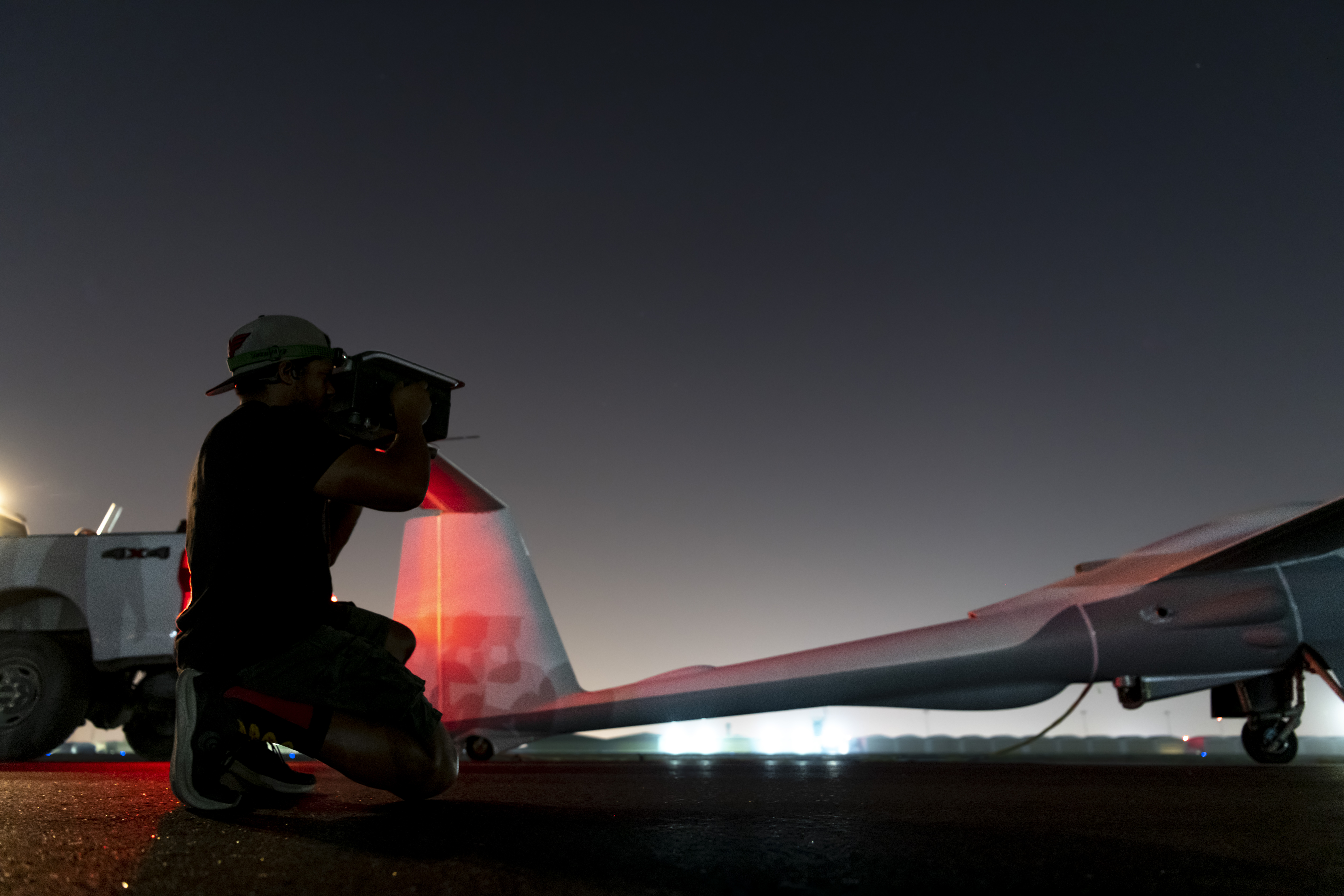 An ULTRA crew chief, assigned within the U.S. Central Command area of responsibility, uses a transponder interrogator to confirm proper transponder function on an ULTRA before an early morning flight at Al Dhafra on May 7, 2024. <em>U.S. Air Force </em>