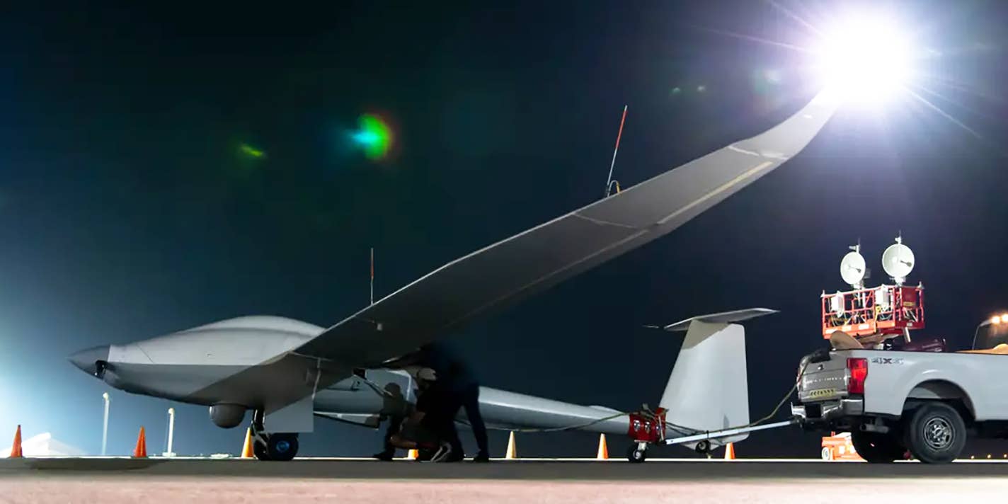 Unmanned Long-Endurance Tactical Reconnaissance Aircraft crew chiefs, assigned within the U.S. Central Command area of responsibility, prep an ULTRA aircraft for taxi across the flightline before an early morning takeoff at an undisclosed location, May 7, 2024. ULTRA is an unmanned aerial system capable of flight times up to 80 hours, providing intelligence, surveillance, and reconnaissance capabilities to combatant commanders, with a smaller operational footprint than other UAS in its class.