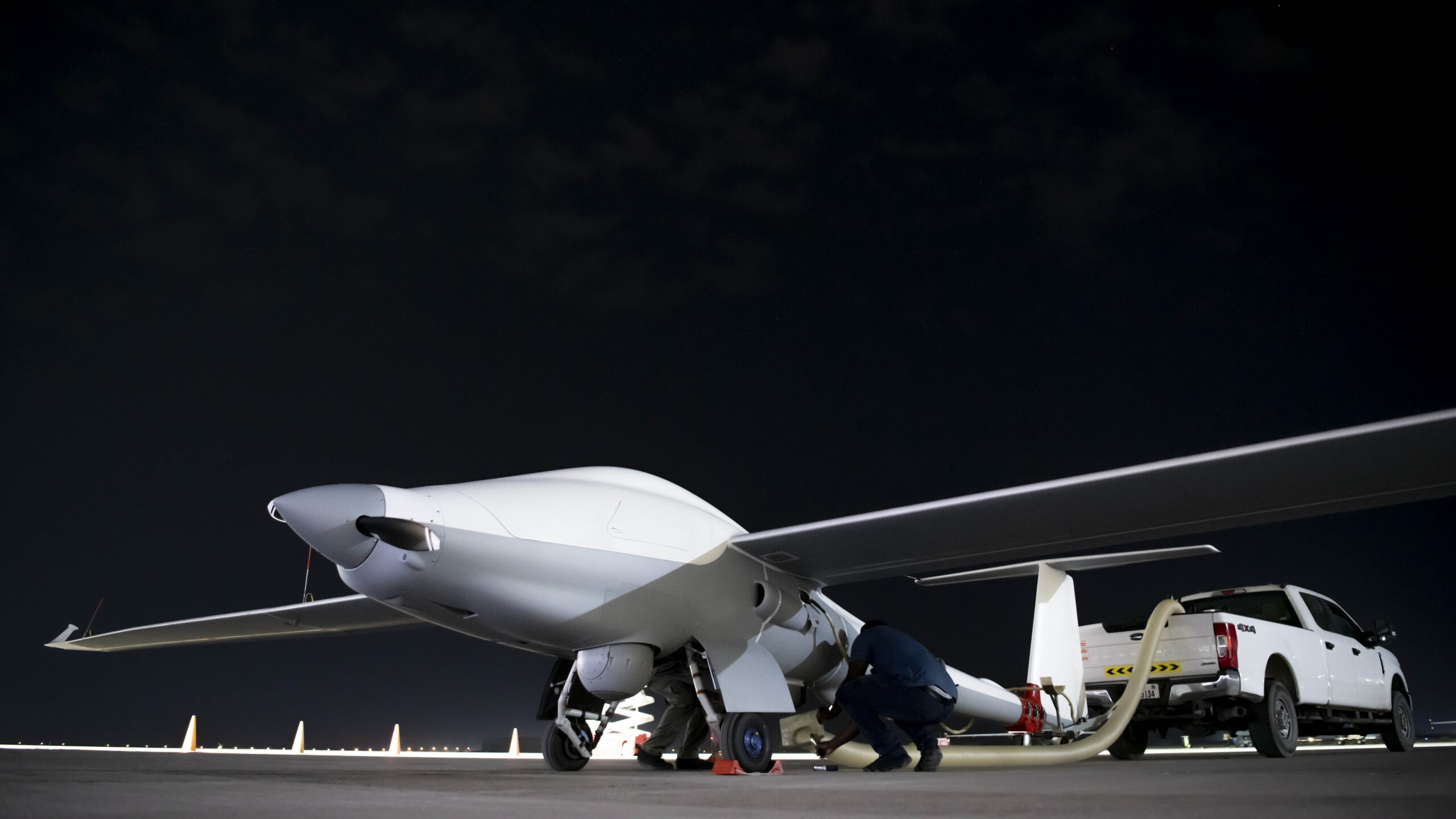 Unmanned Long-Endurance Tactical Reconnaissance Aircraft crew chiefs, assigned within the U.S. Central Command area of responsibility, prep an ULTRA aircraft for taxi across the flightline before an early morning takeoff at an undisclosed location, May 7, 2024. ULTRA is an unmanned aerial system capable of flight times up to 80 hours, providing intelligence, surveillance, and reconnaissance capabilities to combatant commanders, with a smaller operational footprint than other UAS in its class.