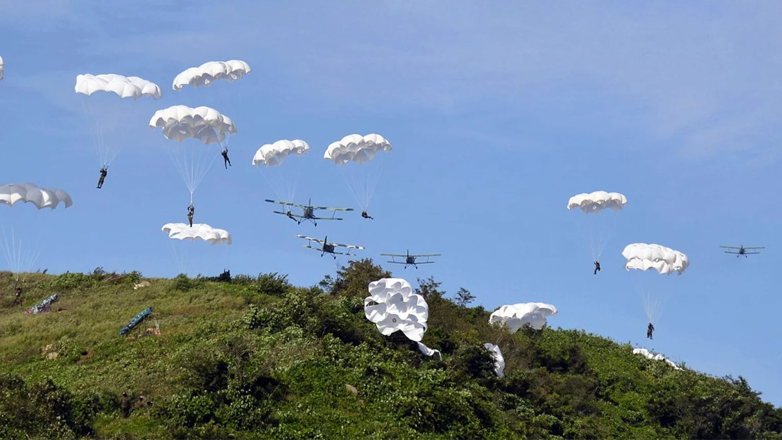 North Korean troops parachute from An-2 biplanes. <em>North Korean State Media</em>