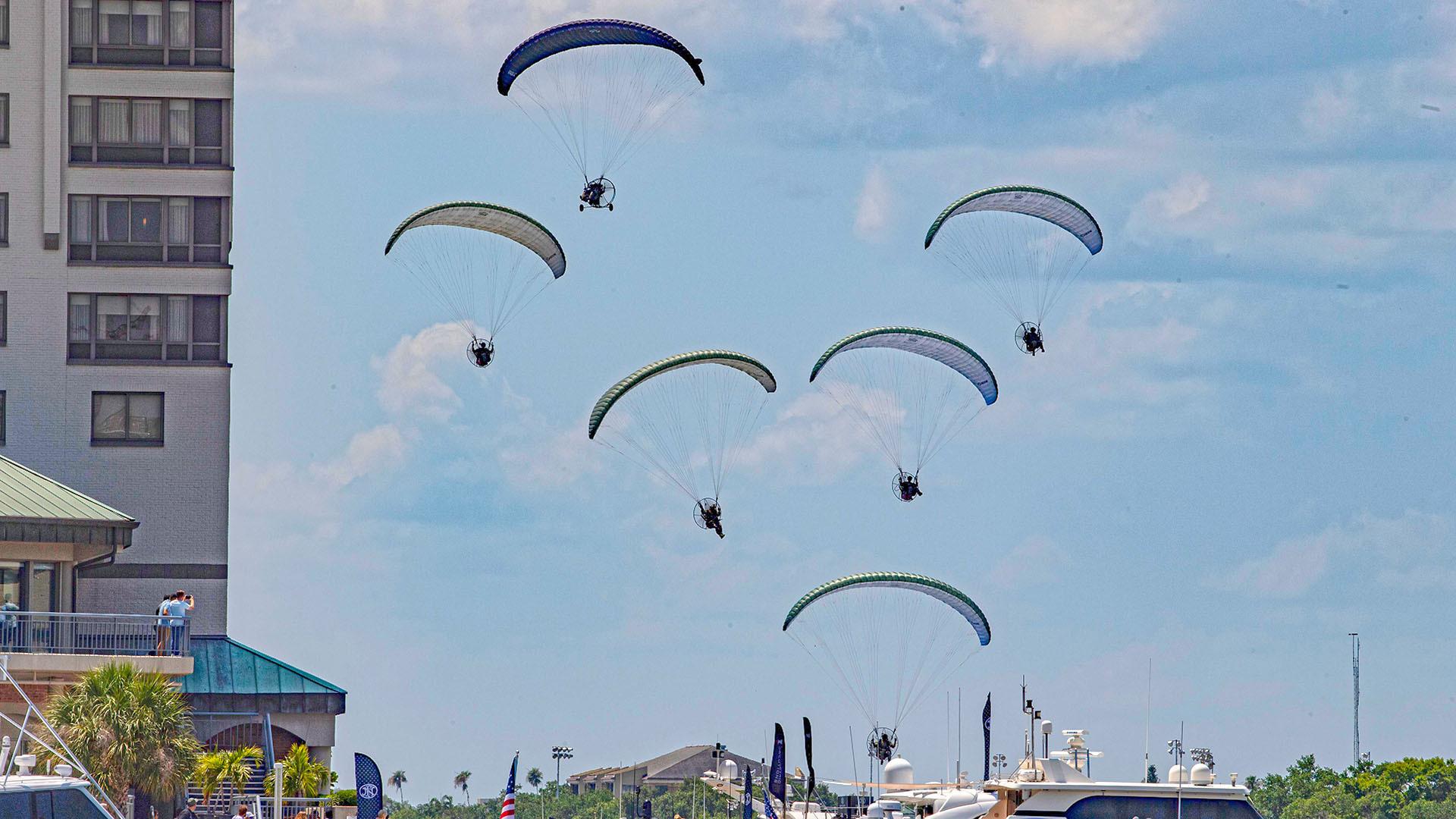Marine special operators using backpack and tricycle buggy-type paragliders descend on Tampa's harbor area on May 7 as part of a rehearsal<em> for the annual</em> SOF Week CAPEX. <em>Jamie Hunter</em>