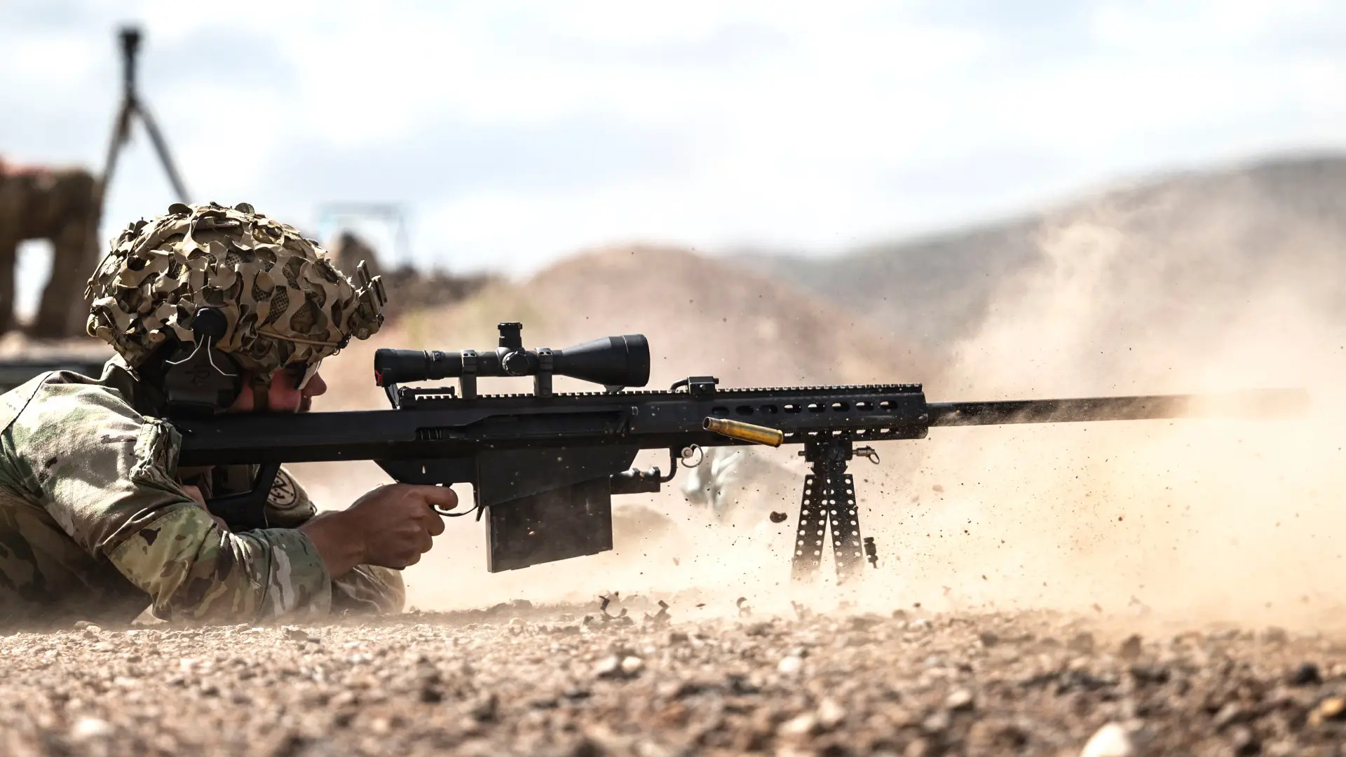 A member of the US military fires a Barrett M82/M107-series .50 caliber semi-automatic sniper/anti-materiel rifle. <em>USAF</em>