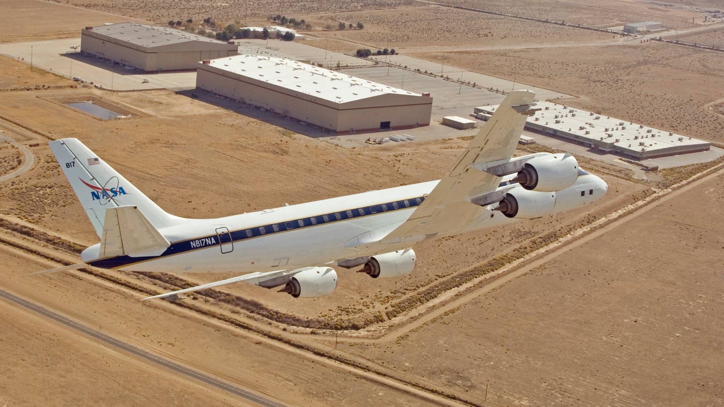 NASA's DC-8 airborne science laboratory banks low over the Dryden Aircraft Operations Facility at Air Force Plant 42 in Palmdale, Calif., upon arrival Nov. 8, 2007.