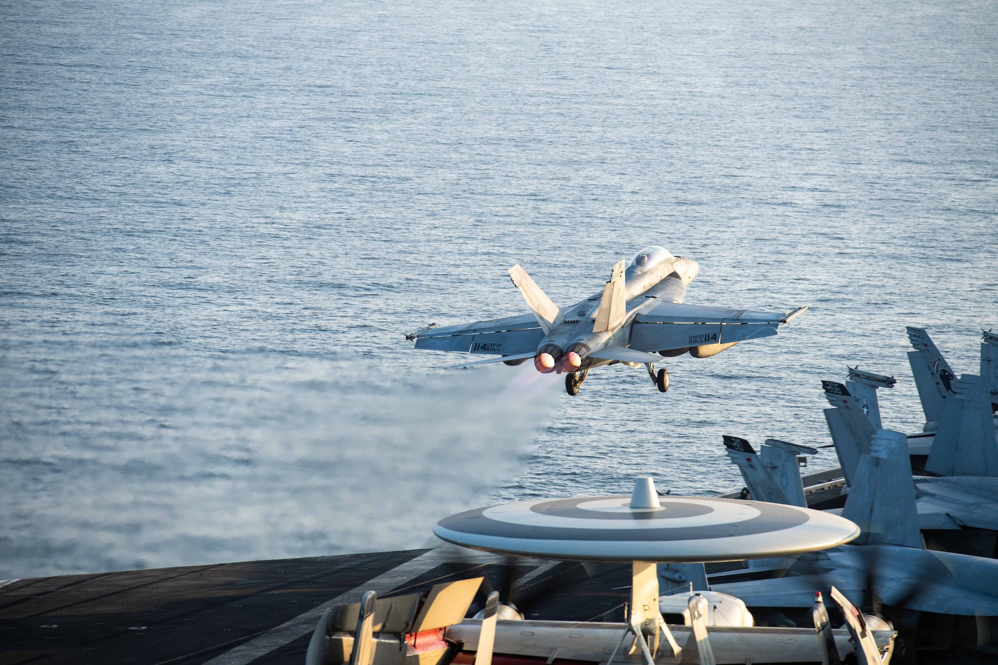 240101-N-HE057-2042 MIDDLE EAST (Jan. 1, 2023) An F/A-18F Super Hornet fighter jet, attached to the "Fighting Swordsmen" of Strike Fighter Squadron (VFA) 32, takes off from the flight deck aboard the aircraft carrier USS Dwight D. Eisenhower (CVN 69) Jan. 1, 2023. The Dwight D. Eisenhower Carrier Strike Group is deployed to the U.S. 5th Fleet area of operations to support maritime security and stability in the Middle East region. (U.S. Navy photo by Mass Communication Specialist 3rd Class Nicholas Rodrigue