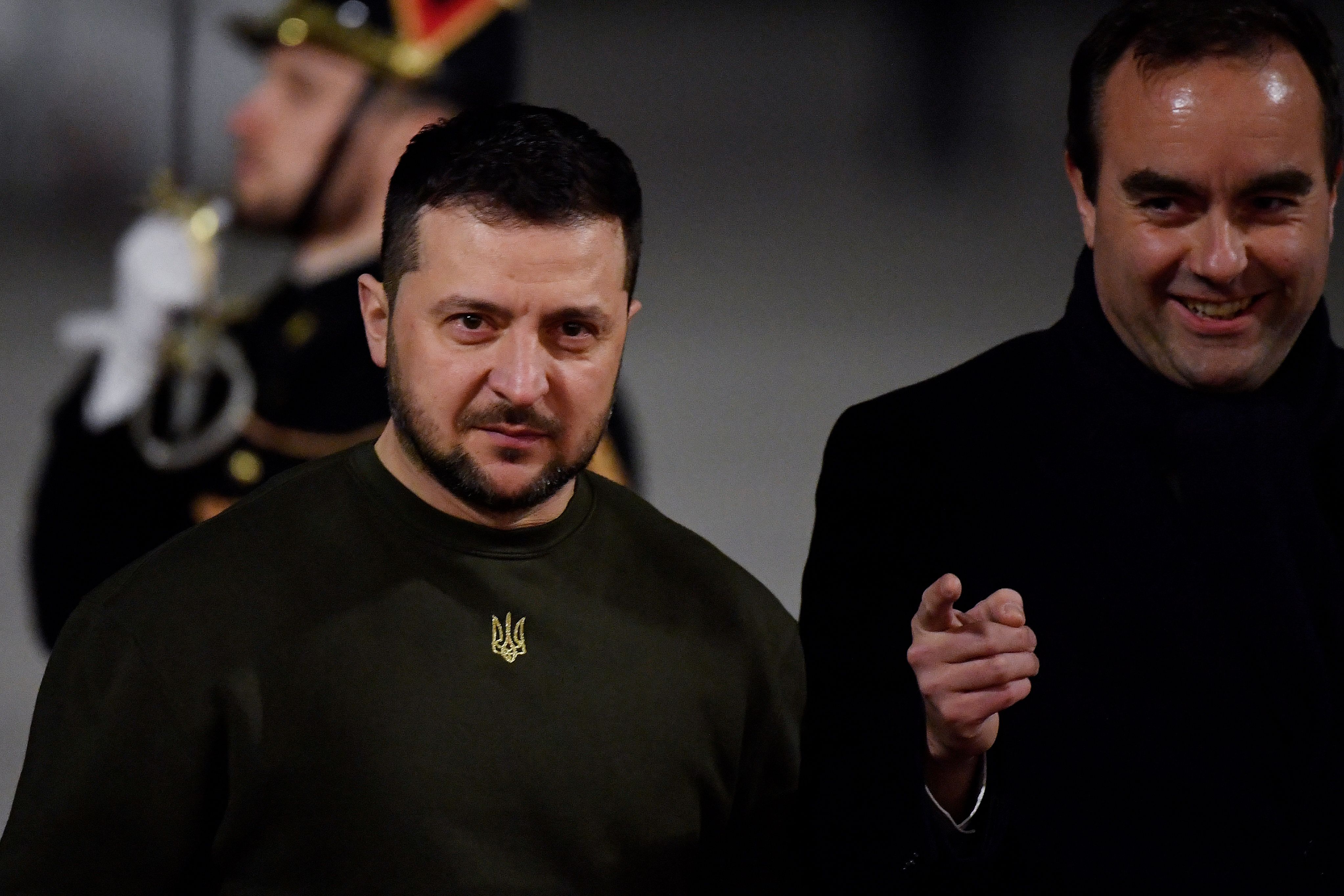 Ukraine's President Volodymyr Zelensky (L) is welcomed by French Armies Minister Sebastien Lecornu (R) upon his arrival at the Paris Orly airport, outside Paris, before taking part in a meeting with France's President and Germany's Chancellor on February 8, 2023, following his visit to the United Kingdom. - EU officials are hoping Zelensky will head to Brussels on February 9 to meet European leaders in a largely symbolic but nevertheless keenly anticipated visit after months of European support for Ukraine. (Photo by JULIEN DE ROSA / POOL / AFP) (Photo by JULIEN DE ROSA/POOL/AFP via Getty Images)