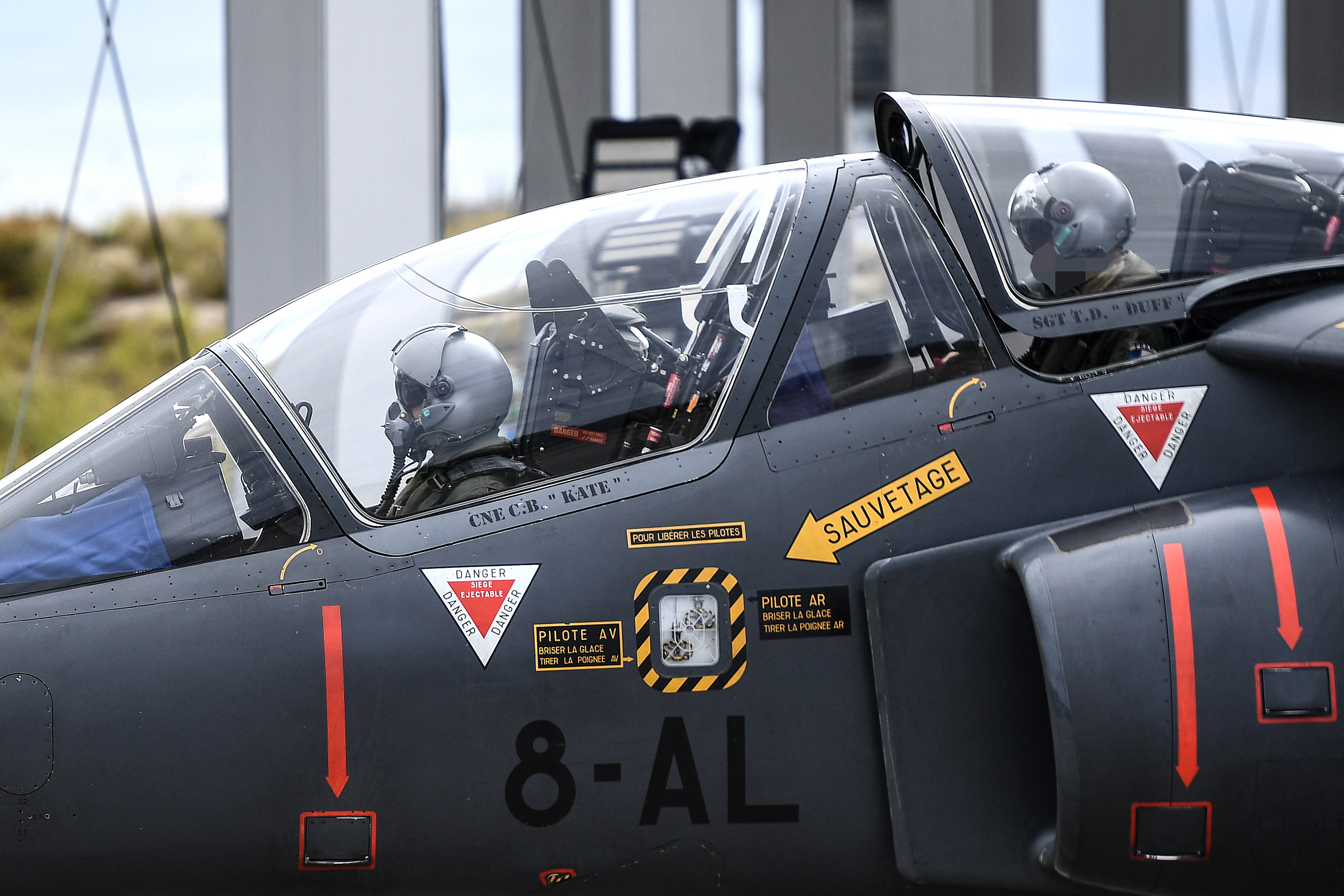 An Ukrainian trainee (L) and a French military instructor (R) move towards a take-off runway for a flight onboard an Alpha Jet fighter jet, at a French Army air base in south-western France on June 14, 2024. In the face of the slow but steady advance of the Russian army in Ukraine, Ukraine urgently needs 120 to 130 fighter jets to end Moscow's dominance in the air, but to operate these technological jewels, operational pilots are needed, which takes months or even years to train. To achieve this, France has committed to training 26 Ukrainian pilots over two years, which represents an effort for its Air Force, which is used to instructing about 30 French pilots per year, as well as proposing the transfer of several Mirage 2000-5s. (Photo by Christophe ARCHAMBAULT / AFP) (Photo by CHRISTOPHE ARCHAMBAULT/AFP via Getty Images)