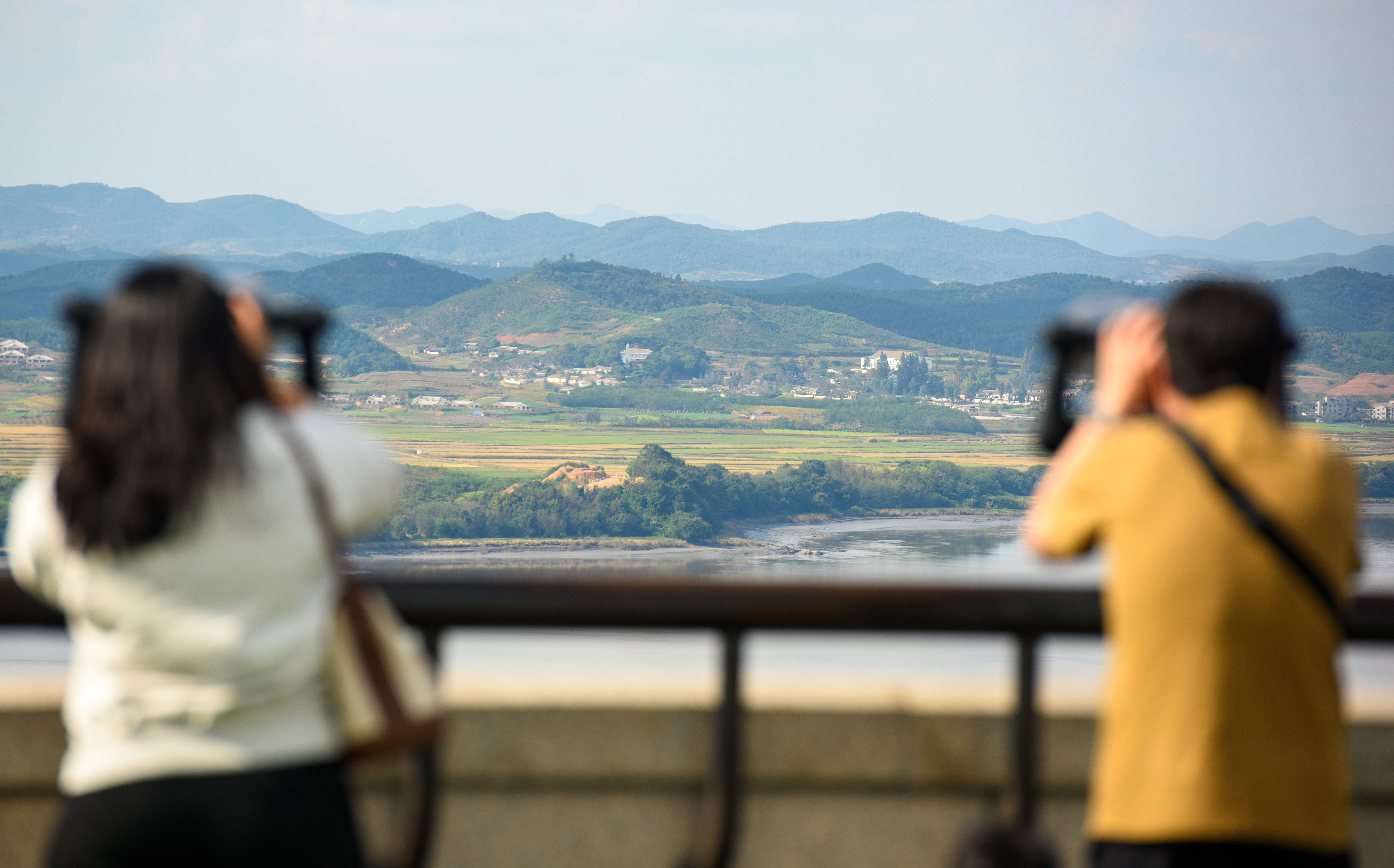 PAJU, SOUTH KOREA - 2024/10/09: Visitors use binoculars to look at the North Korean side of the Demilitarised Zone (DMZ) dividing the two Koreas, from South Korea's Unification Observatory in Paju, north of Seoul. The North Korean military said it will block all roads and railways connected to South Korea from October 9 and establish a "strong defense structure" in the area in response to the South Korean-U.S. military maneuvers. (Photo by Kim Jae-Hwan/SOPA Images/LightRocket via Getty Images)