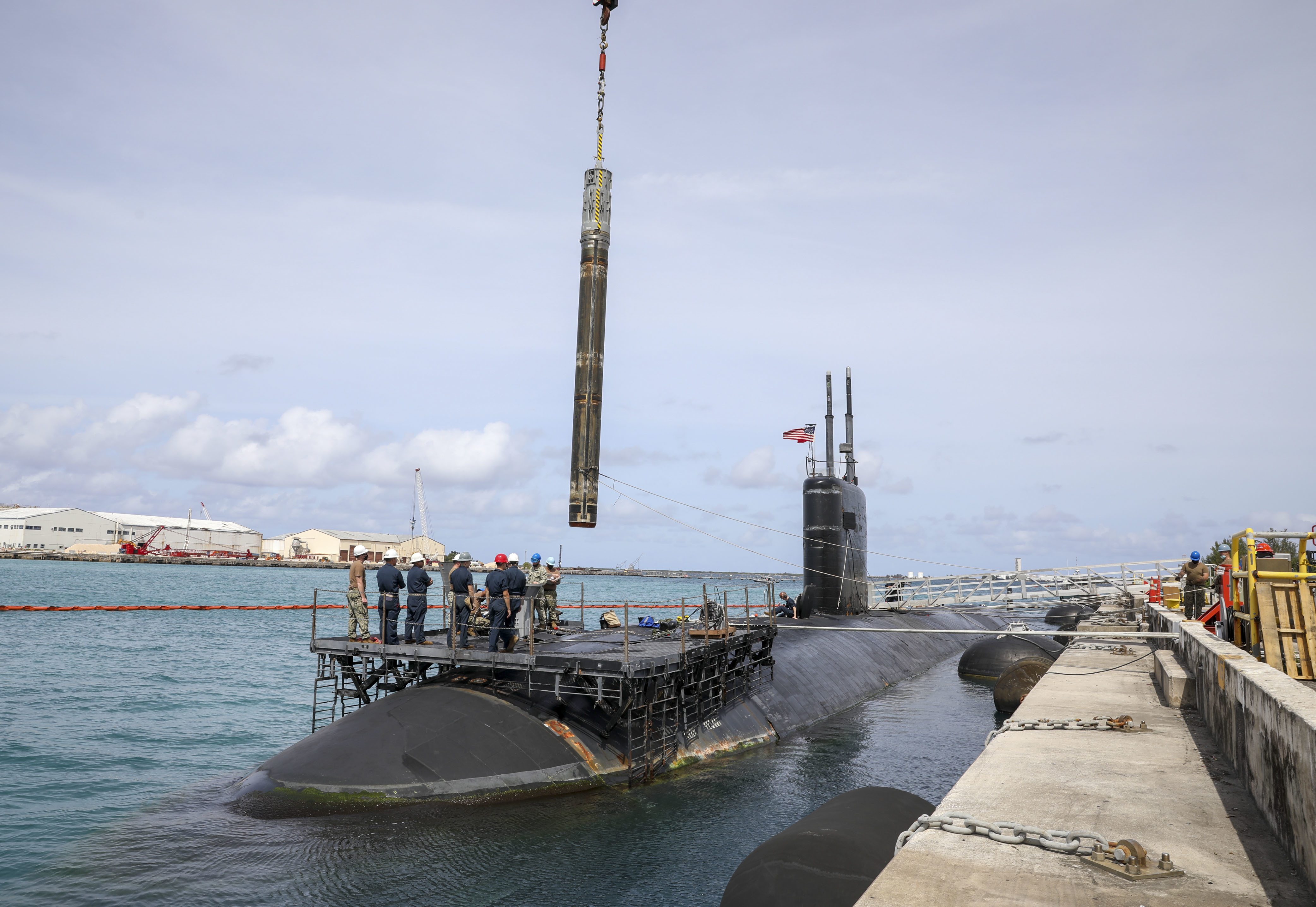 POLARIS POINT, Guam (Feb. 1, 2022) Sailors assigned to the submarine tender USS Emory S. Land (AS 39) weapons handling division conduct an offload of a Tomahawk missile from the Los Angeles-class fast-attack submarine USS Asheville (SSN 758), Feb 1. Land is one of two U.S. Navy submarine tenders that provide maintenance, hotel services and logistical support to submarines and surface ships in the U.S. 5th and 7th Fleet areas of operation. (U.S. Navy photo by Mass Communication Specialist 1st Class Victoria Kinney)
