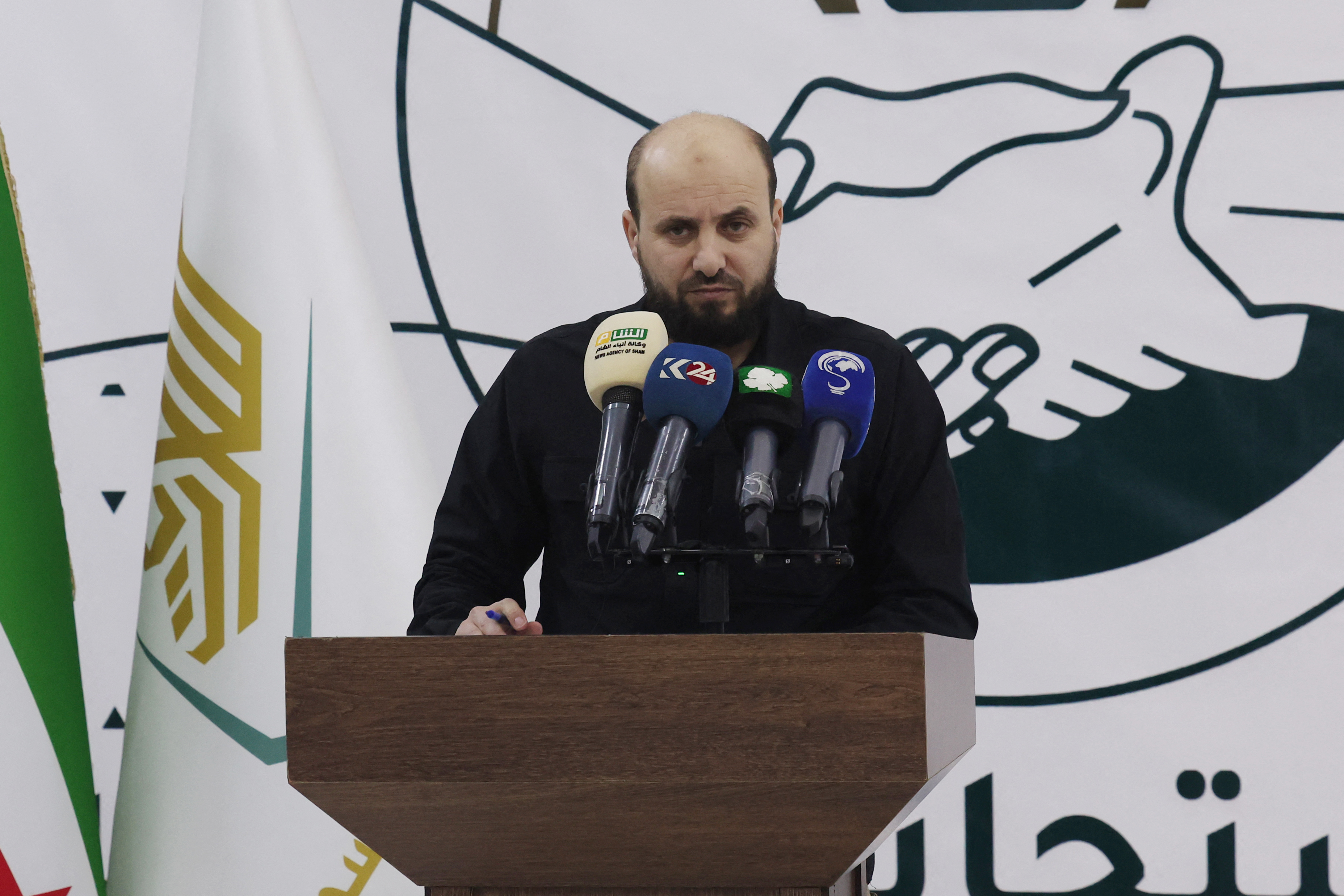 Mohamed Bashir, who heads HTS's so-called "Salvation Government", holds a press conference in the rebel-held northwestern Syrian city of Idlib on November 28, 2024. A Syria war monitor said on November 28 that clashes between the army and an alliance of the jihadist group Hayat Tahrir al-Sham (HTS) with other opposition factions killed more than 130 combatants in the worst fighting in the country's northwest in years, as the government also reported fierce battles. Some of the clashes, which are happening in an area straddling Idlib and Aleppo provinces, are less than 10 kilometres (six miles) southwest of the outskirts of Aleppo city, which is under government control. (Photo by Omar HAJ KADOUR / AFP) (Photo by OMAR HAJ KADOUR/AFP via Getty Images)