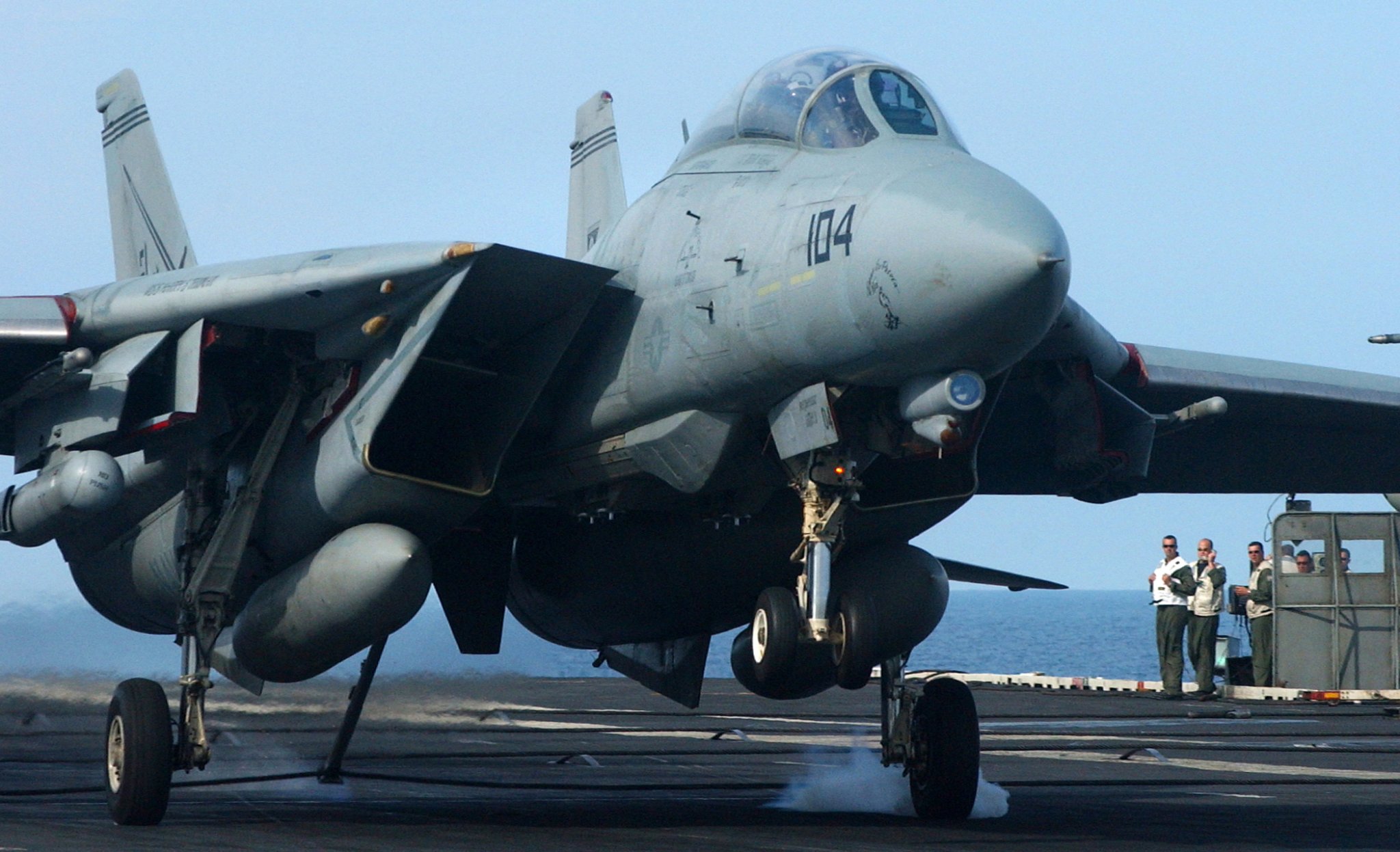 050714-N-5345W-093 Atlantic Ocean (July 14, 2005) – Landing Signal Officers watch as an F-14B Tomcat, assigned to the "Swordsmen" of Fighter Squadron Three Two (VF-32), catches an arresting wire with its tail hook aboard the Nimitz-class aircraft carrier USS Harry S. Truman (CVN 75). Truman is currently conducting carrier qualifications and operations off the East Coast and is also participating in a Joint Task Force Exercise (JTFEX) with USS Theodore Roosevelt (CVN 71). JTFEX is a key component in the training cycle of an aircraft carrier and carrier air wing in the U.S. Navy Fleet Response Plan. U.S. Navy photo by Photographer's Mate 3rd Class Kristopher Wilson (RELEASED)
