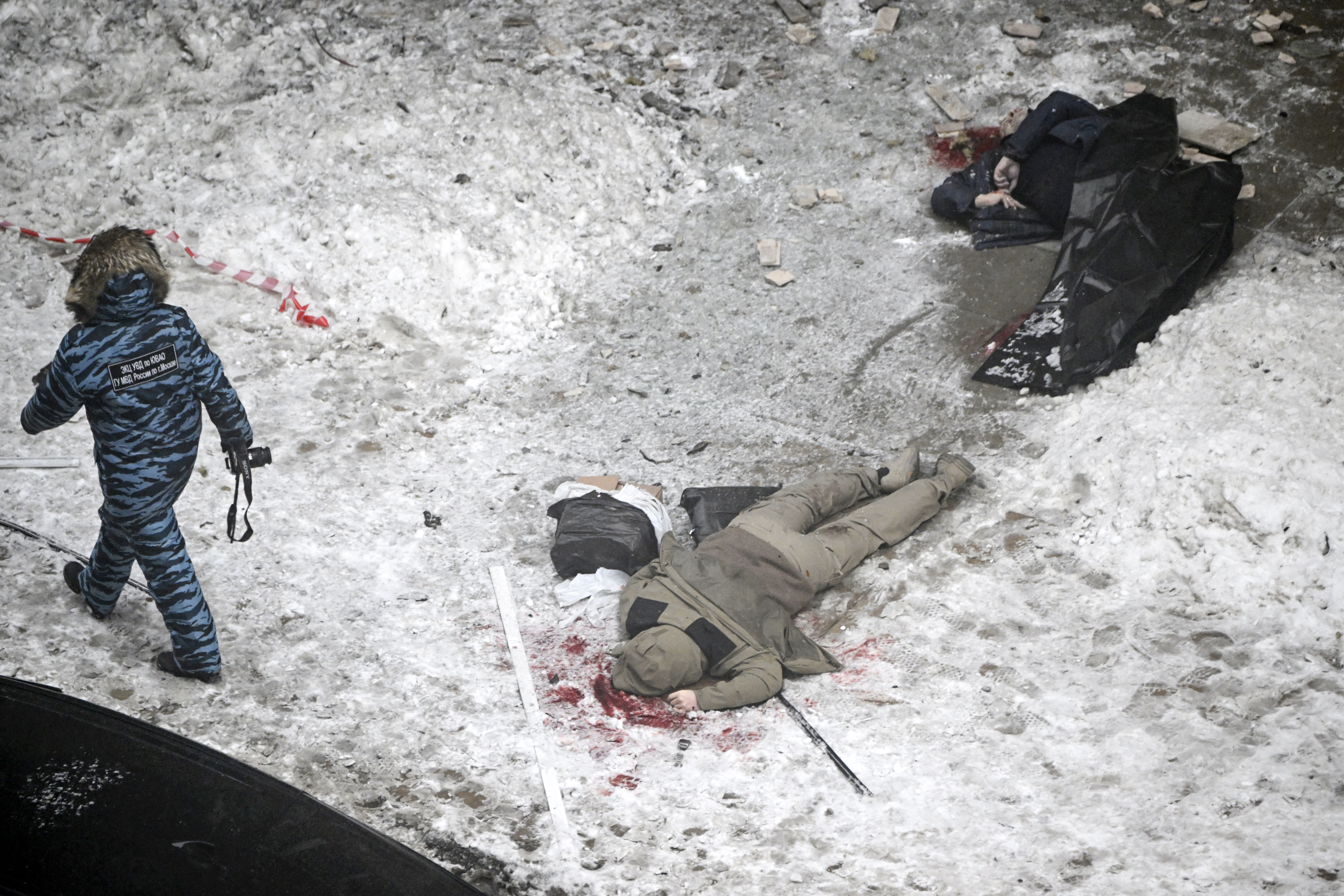 EDITORS NOTE: Graphic content / Bodies are seen at the blast scene, which killed the commander of Russian armed forces' chemical, biological and radiation defence troops, Igor Kirillov, and his assistant, according to the Russian Investigative Committee, outside a residential building on Ryazansky Avenue in Moscow on December 17, 2024. (Photo by Alexander NEMENOV / AFP) (Photo by ALEXANDER NEMENOV/AFP via Getty Images)