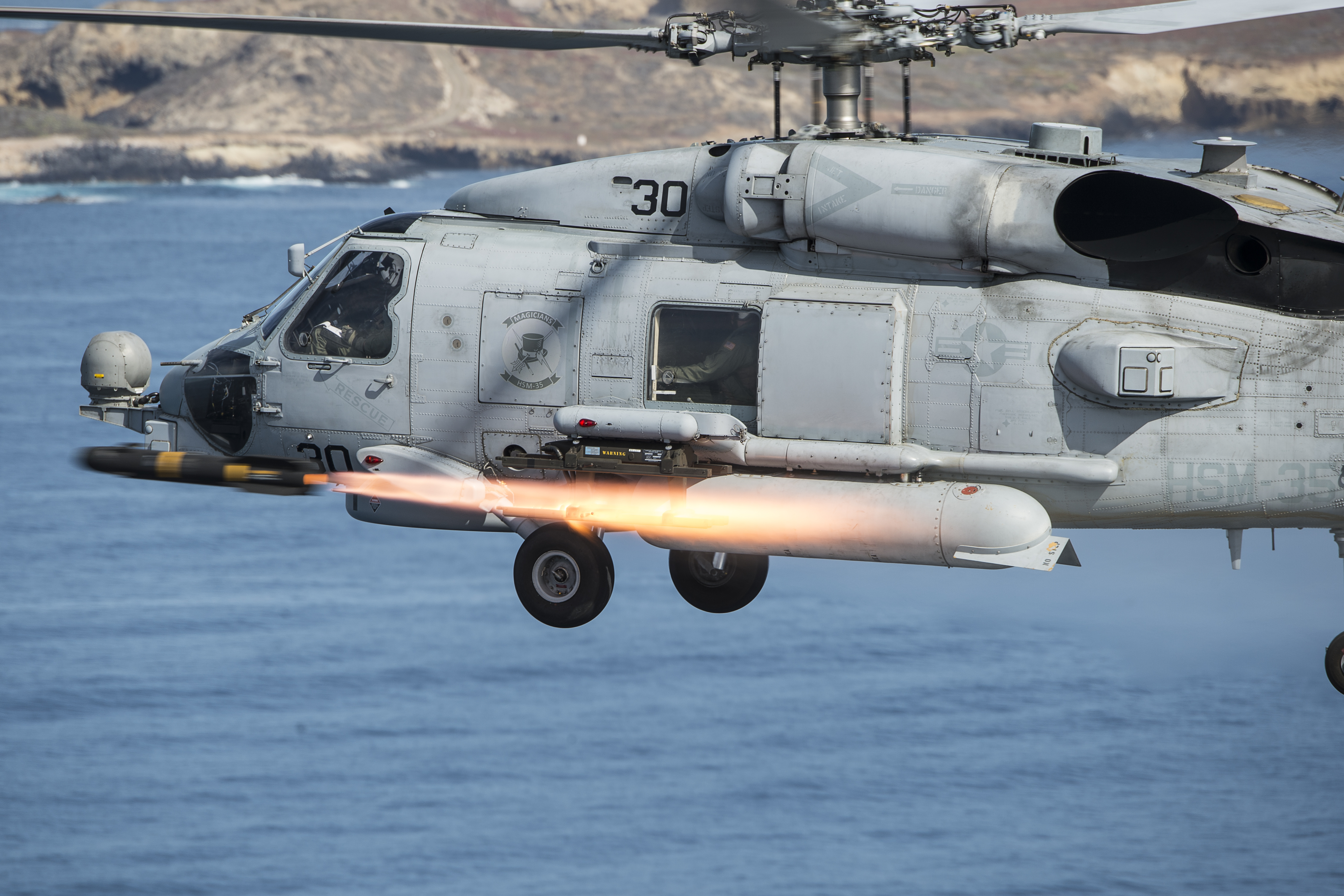An MH-60R Sea Hawk helicopter, assigned to Helicopter Maritime Strike Squadron (HSM) 35, fires an AGM-114M Hellfire missile, April 5, 2016, near San Clemente Island, California, during a live-fire combat training exercise. HSM-35, the Navy's first composite expeditionary helicopter squadron, flies the MH-60R Sea Hawk helicopter and MQ-8B Fire Scout unmanned aircraft system. (U.S. Navy Combat Camera photo by Mass Communication Specialist 2nd Class Arthurgwain L. Marquez/Released)