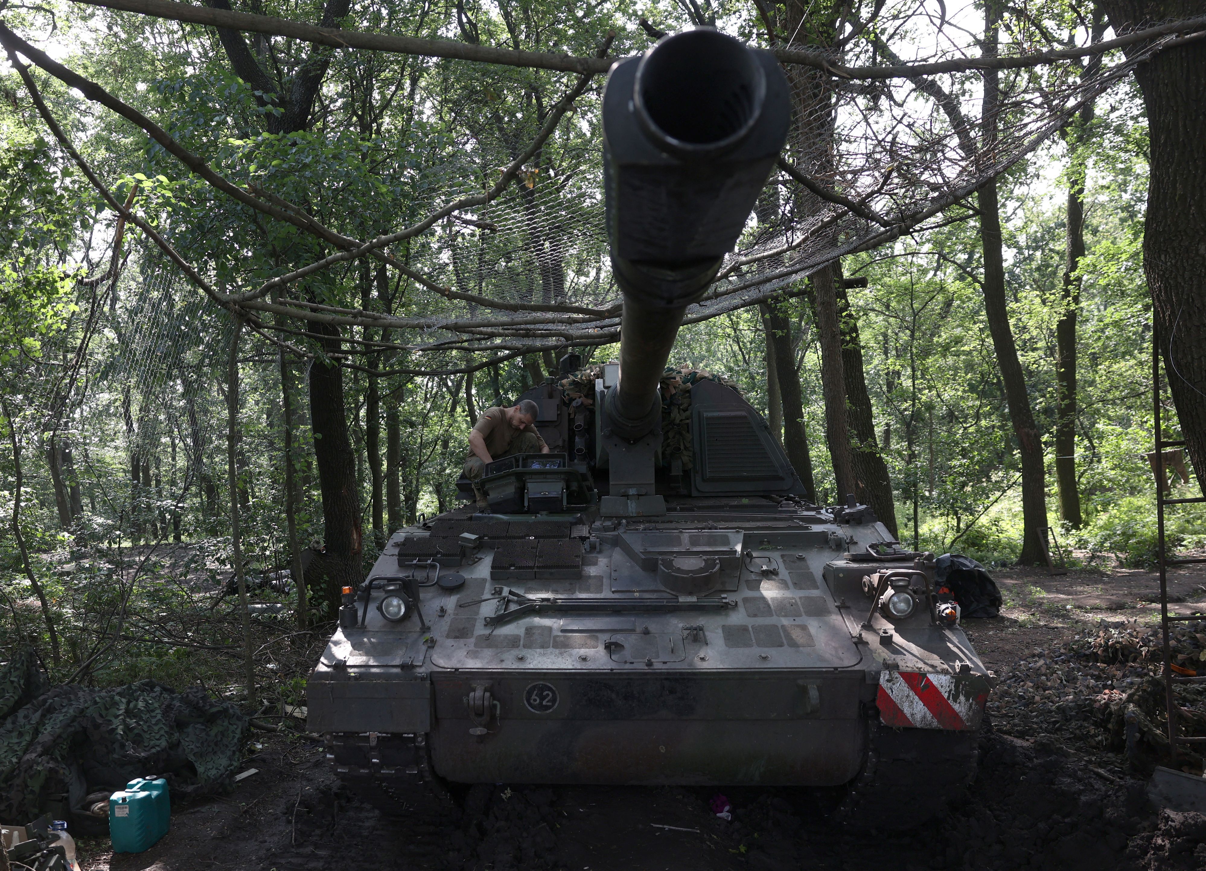 A Ukrainian serviceman of the 43rd Artillery Brigade works on a 155 mm self-propelled howitzer Panzerhaubitze 2000 (PzH 2000), towards Russian positions at a front line near Bakhmut, Donetsk region on June 15, 2023, amid the Russian invasion of Ukraine. (Photo by Anatolii Stepanov / AFP) (Photo by ANATOLII STEPANOV/AFP via Getty Images)