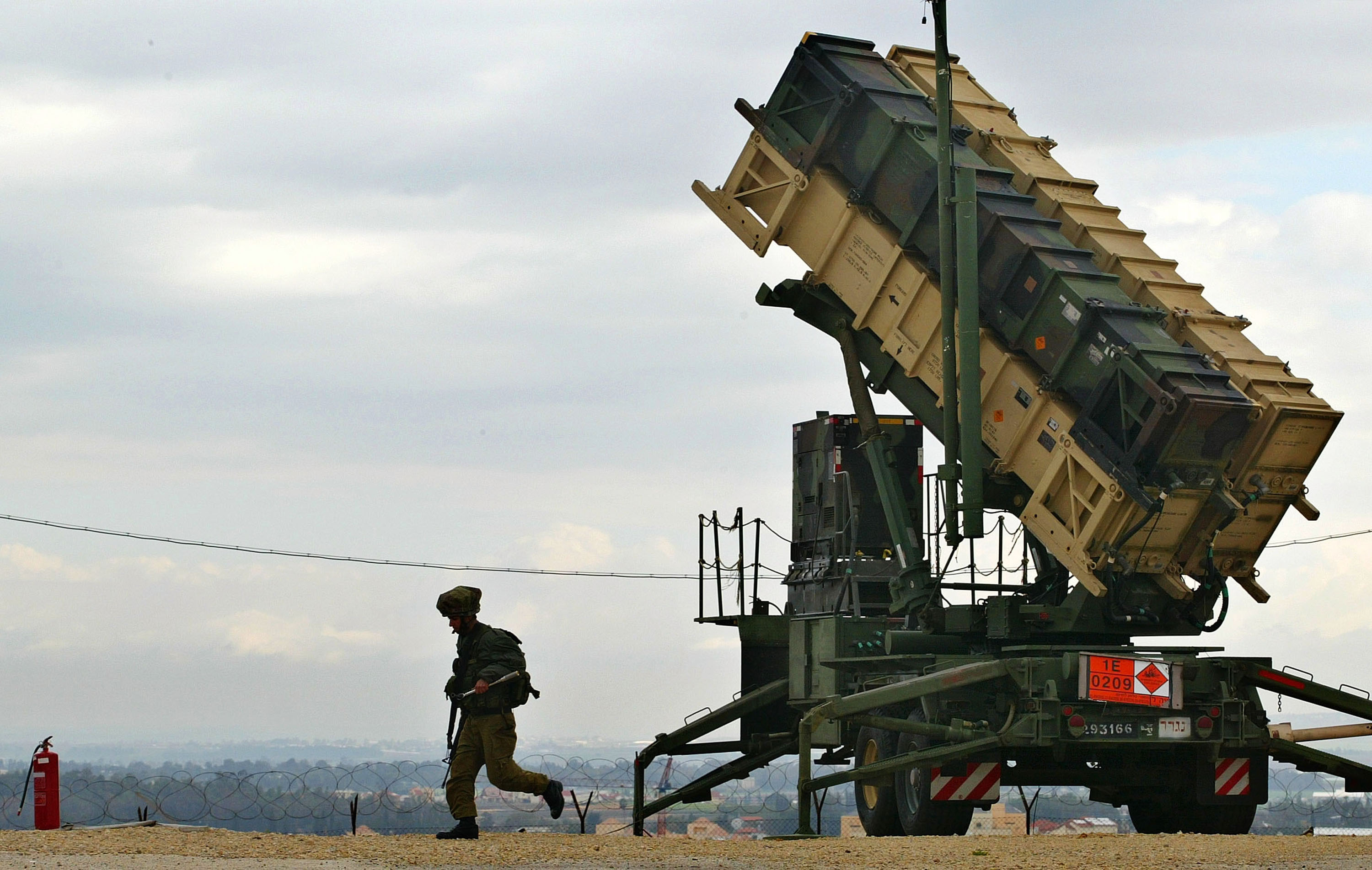 HAFETZ HAYIM, ISRAEL - FEBRUARY 27: An Israeli soldier runs from a Patriot missile launcher February 27, 2003 as the anti-aircraft and anti-ballistic missile missile is ready to launch from Hafetz Hayim army base near the town of Gadera, Israel. The Israeli army demonstrated the readiness of its improved Patriot system to the press ahead of an expected coalition attack against Iraq. In the 1991 Gulf War, the Baghdad regime launched 39 Scud missiles against the Jewish state. (Photo by David Silverman/Getty Images)
