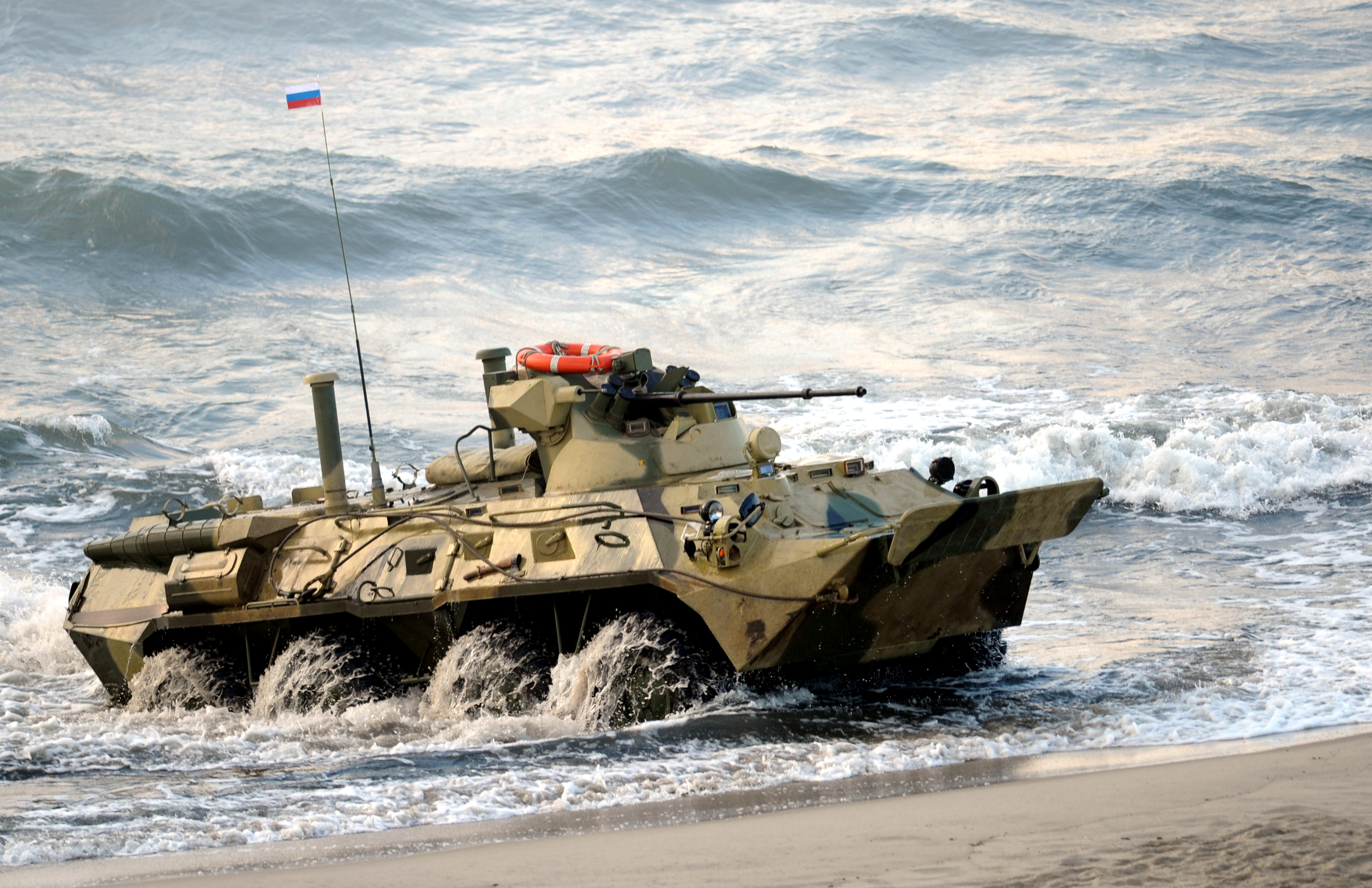 A picture taken on September 26, 2013, shows a Russian-built BTR-82A amphibious armoured personnel carrier lands on the seashore during a joint military exercises of Russian and Belarus troops at the Khmelevka firing range in the Russia's enclave of Kaliningrad. AFP PHOTO/ RIA-NOVOSTI/ POOL /ALEXEY DRUZHININ (Photo credit should read ALEXEY DRUZHININ/AFP via Getty Images)
