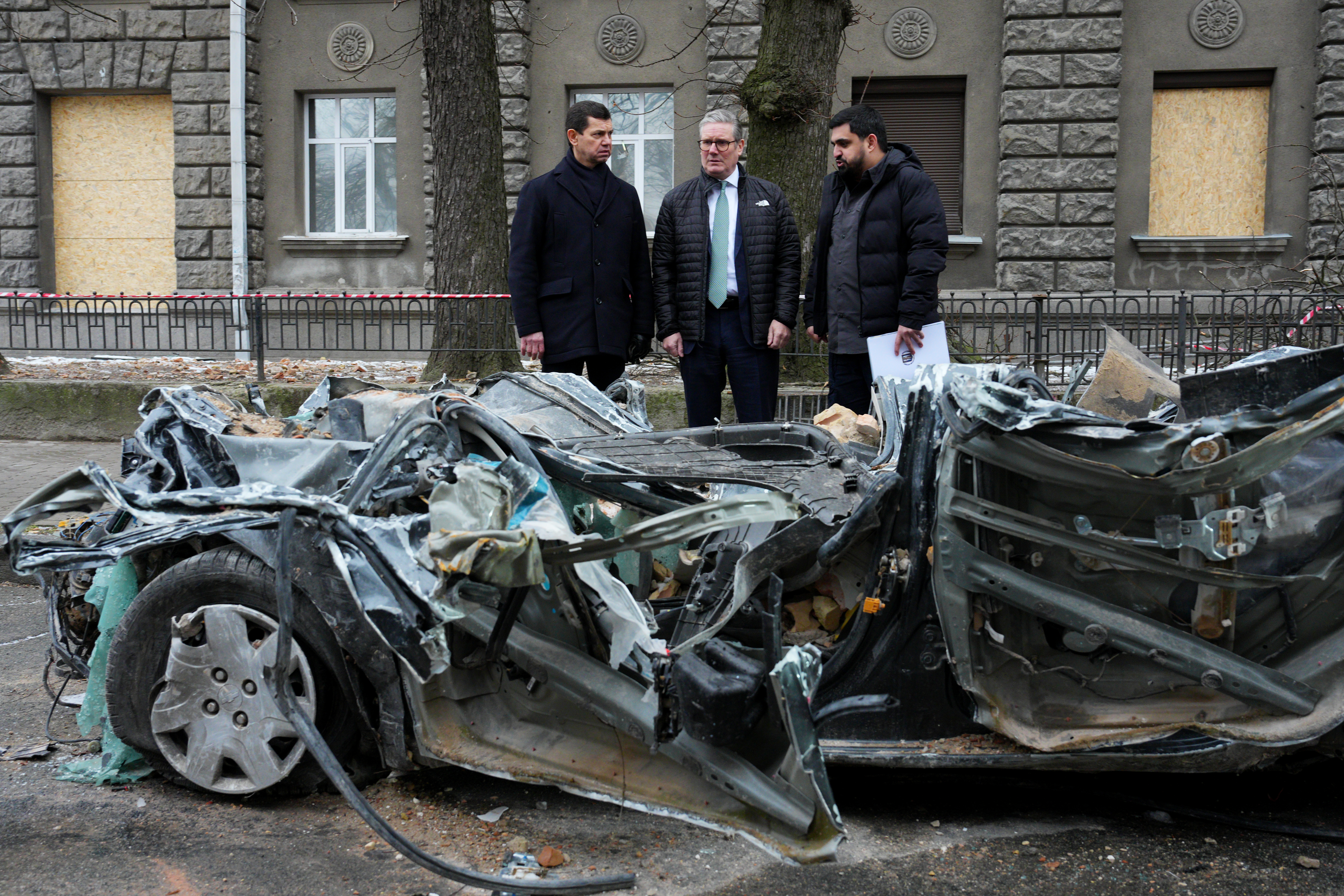 Prime Minister Sir Keir Starmer is guided by Ukrainian officials as he inspects a damaged vehicle along a street in Kyiv, during his visit to Ukraine to sign a new long-term partnership deal with Volodymyr Zelensky. The 100 Year Partnership includes defence and scientific collaboration but will also forge new community links between the UK and Ukraine. Picture date: Thursday January 16, 2025. (Photo by Carl Court/PA Images via Getty Images)