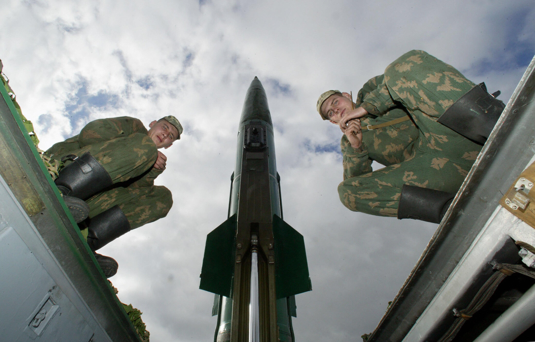 Kaliningrad, RUSSIAN FEDERATION: Russian soldiers sit on the launcher of Tochka-M (Point-M), short range missile, which has a range of about 44 miles (70 kilometres) prior its launch at the military training ground outside Russian enclave of Kaliningrad, 05 October 2005. AFP PHOTO (Photo credit should read STRINGER/AFP via Getty Images)
