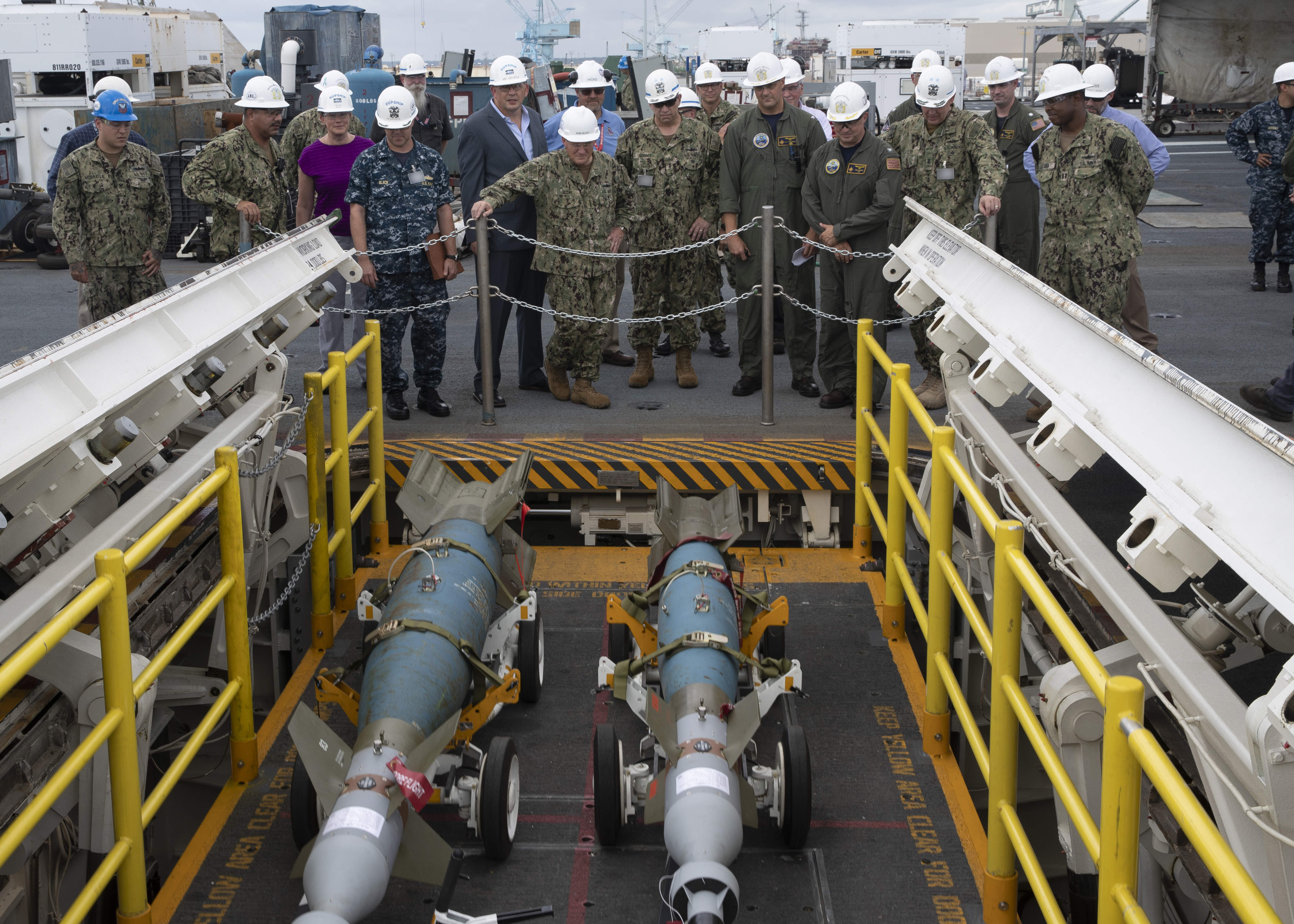 190828-N-YW264-2128 NEWPORT NEWS, Va. (Aug. 28, 2019) Chief of Naval Operations (CNO) Adm. Mike Gilday watches USS Gerald R. Ford’s (CVN 78) advanced weapons elevators (AWE) during a visit to the ship. Gilday visited Ford to visit with Sailors and see the ship’s progress during its post-shakedown availability. (U.S. Navy photo by Mass Communication Specialist Seaman Zachary Melvin) (This photo has been altered for security purposes by blurring badges)